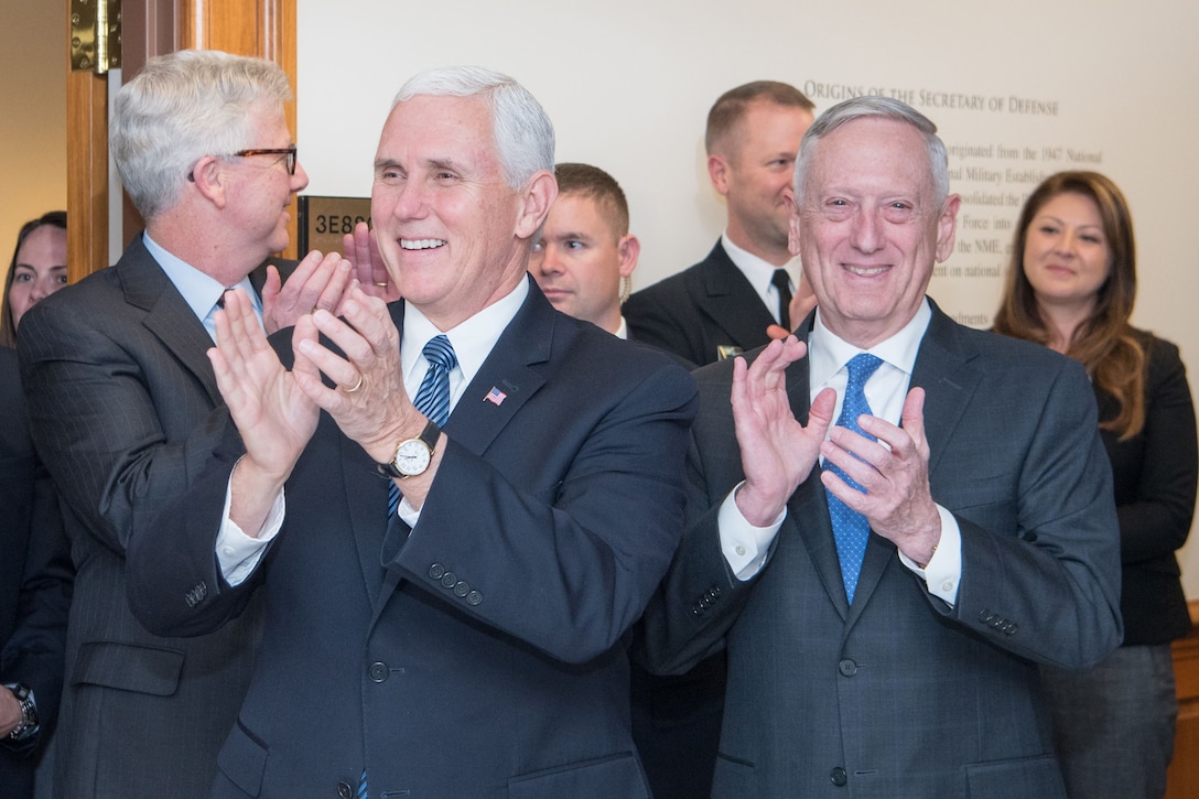 Defense Secretary James N. Mattis and Vice President Mike Pence applaud.