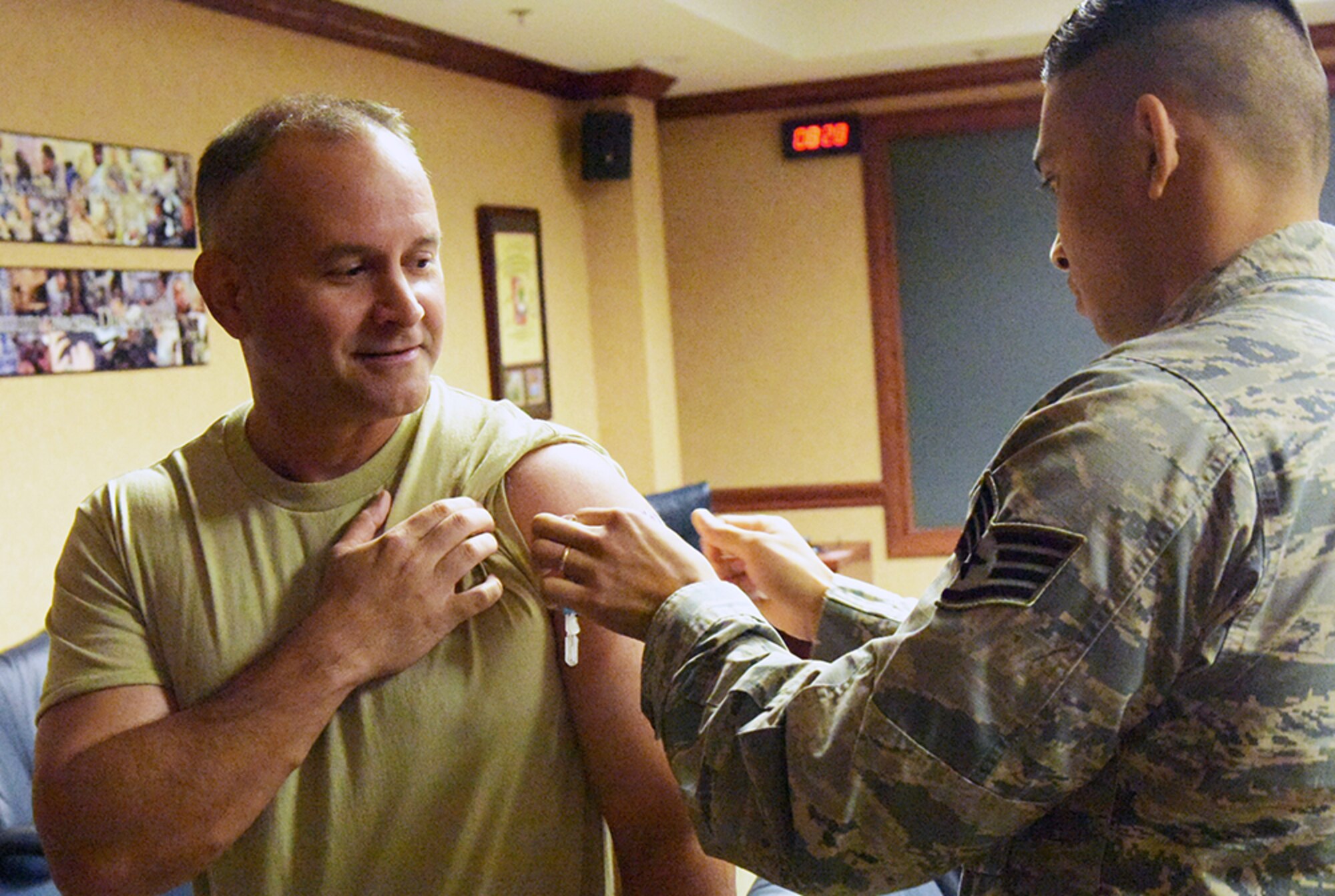Staff Sgt. Tam Nguyen, 78th Medical Group Immunization Clinic noncommissioned officer in charge, administers a flu shot to Chief Master Sergeant Emilio Hernandez, 78th ABW command chief. The Influenza vaccine is here and available for all TRICARE beneficiaries. The goal is to have 90 percent of the active duty and Reserve population vaccinated by Dec. 15. Group commanders and first sergeants will coordinate with the immunization clinic to schedule a point of distribution to administer the vaccine within their groups. There is no need to schedule an appointment, walk-ins are accepted in the immunization clinic, Mondays through Fridays from 7:30 a.m. to 4:30 p.m. (U.S. Air Force photo/RAYMOND CRAYTON, JR.)