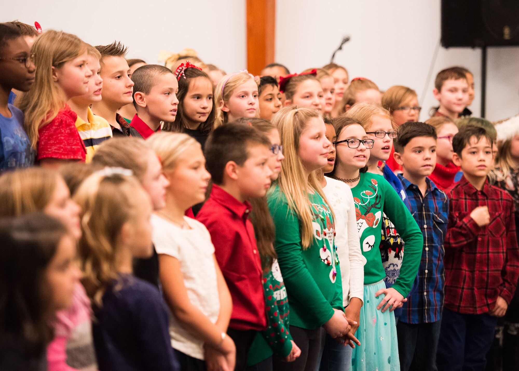 Students from Major George S. Welch Elementary School perform Christmas carols at the 2017 Dover Air Force Base Holiday Tree Lighting ceremony Dec. 5, 2017, at Chapel 2 at the Eagle Heights family housing at Dover Air Force Base, Del.