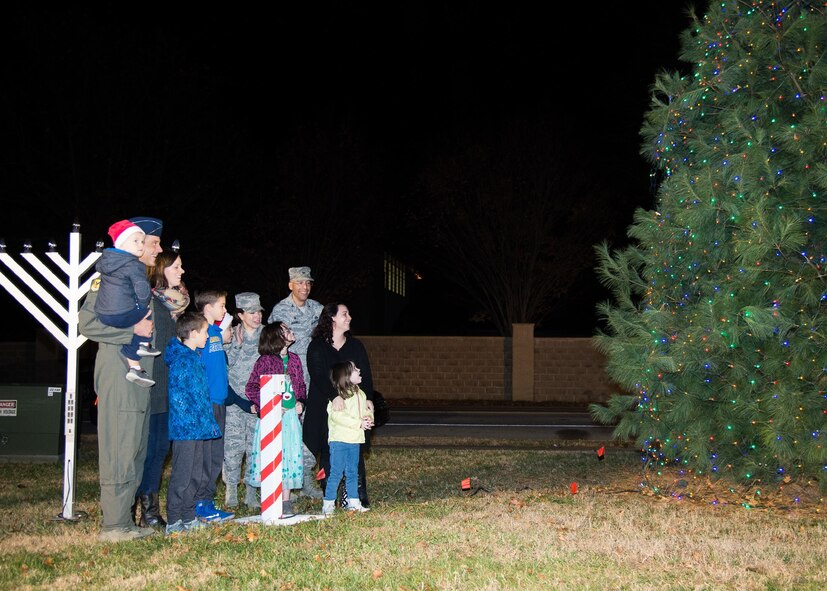 Col. Ethan Griffin, 436th Airlift Wing commander, Mrs. Griffin, Chief Master Sgt. Sarah Sparks, 436th AW command chief, Col. Randy Boswell, 436th Mission Support Group commander, and the family of Master Sgt. Shane Harvey, 436th Maintenance Squadron, light the base Christmas Tree during the 2017 Christmas Tree Lighting ceremony Dec. 5, 2017, at Chapel 2 on Dover Air Force Base, Del.