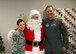 Col. Ethan Griffin, 436th Airlift Wing commander, Chief Master Sgt. Sarah Sparks, 436th Airlift Wing command chief, pose with Santa Claus at the conclusion of the Christmas Tree Lighting ceremony Dec. 5, 2017, at Chapel 2 at the Eagle Heights family housing on Dover Air Force Base, Del.