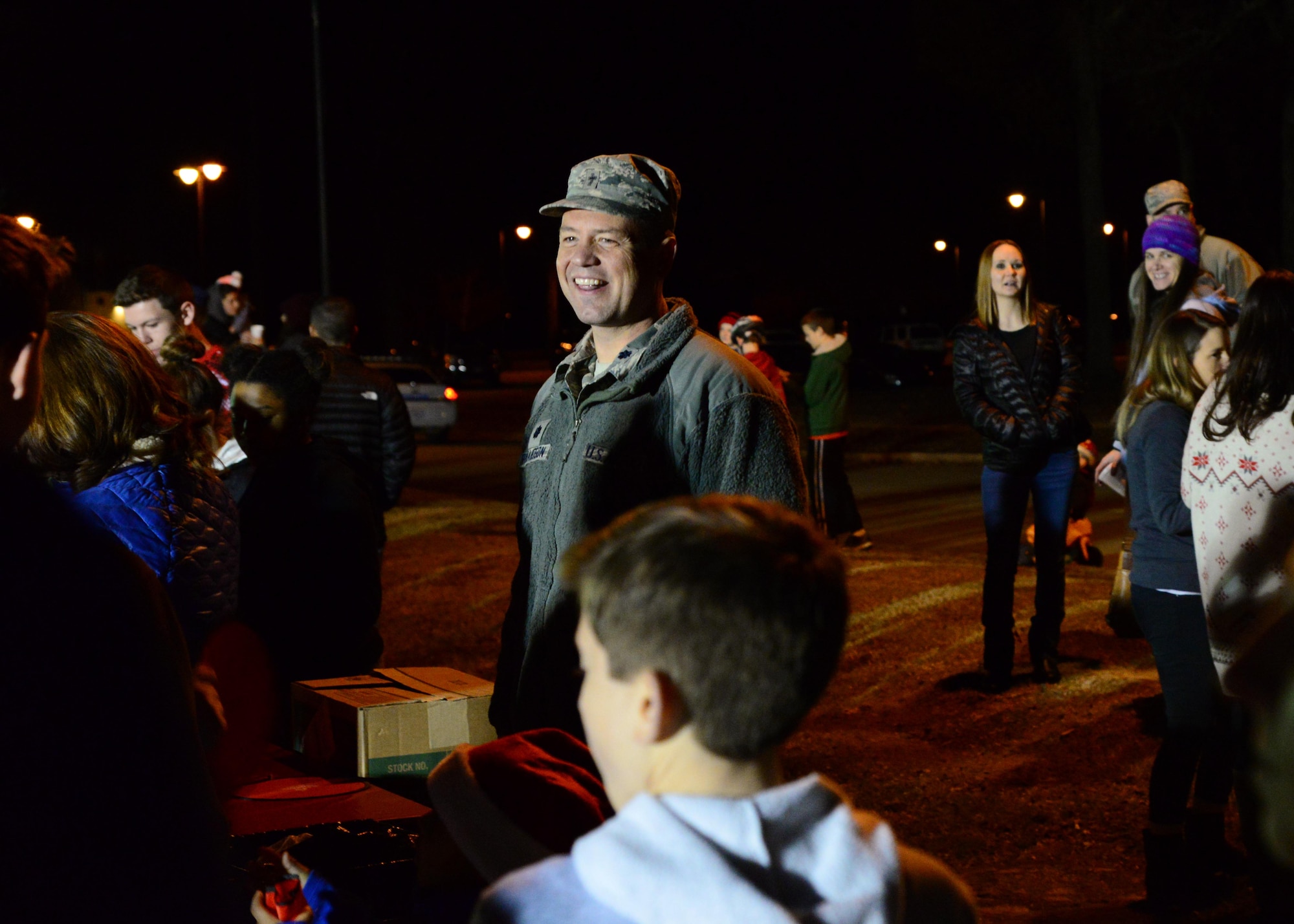 Lt. Col. Steven Richardson, 14th Flying Training Wing Chaplain, serves cookies to members of Team BLAZE at the base Christmas tree lighting Dec. 6, 2017, on Columbus Air Force Base, Mississippi. Cookies and drinks were provided by various base organizations, and the Caledonia 5th grade Choir performed Christmas carols during the event. (U.S. Air Force photo by Airman 1st Class Beaux Hebert)