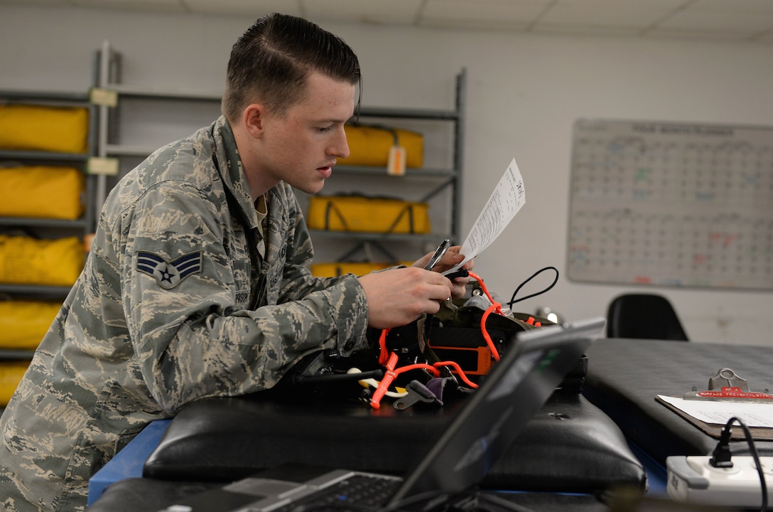 Senior Airman Hayden Harrison, 48th Flying Training Wing Aircrew Flight Equipment technician, reads a T-6A Texan II survival equipment checklist Dec. 5, 2017, on Columbus Air Force Base, Mississippi. The T-6 and T-38C Talon have survival kits inside of the cockpit with each pilot and are an essential portion of the AFE mission. (U.S. Air Force photo by Airman 1st Class Keith Holcomb)