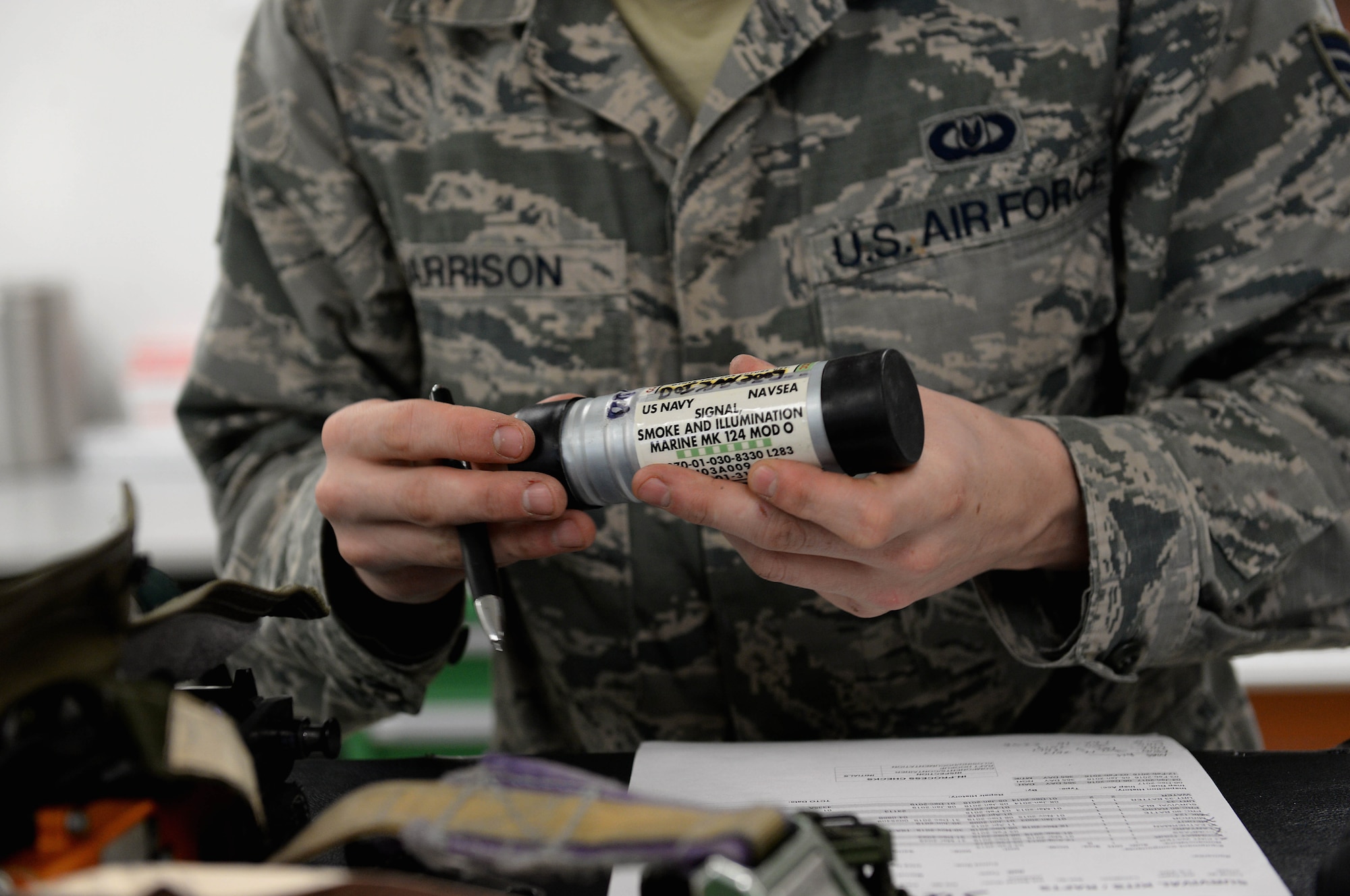 Senior Airman Hayden Harrison, 48th Flying Training Wing Aircrew Flight Equipment technician, checks a part from a T-6A Texan II survival equipment checklist Dec. 5, 2017, on Columbus Air Force Base, Mississippi. Every piece of a survival kit has a matching serial number and expiration date that must be checked and updated as necessary. (U.S. Air Force photo by Airman 1st Class Keith Holcomb)