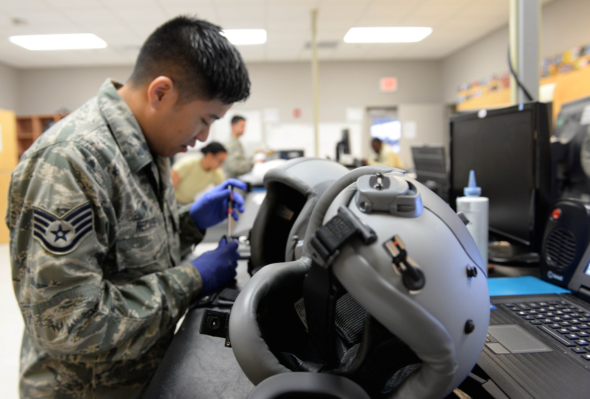 Staff Sgt. Jeremiah Necaise, 41st and 37th Flying Training Squadron Aircrew Flight Equipment technician, replaces parts on multiple helmets Dec. 5, 2017, on Columbus Air Force Base, Mississippi. Every helmet is made to fit every student individually, and the 41st and 37th FTS AFE Airmen take care of over 400 helmets. (U.S. Air Force photo by Airman 1st Class Keith Holcomb)