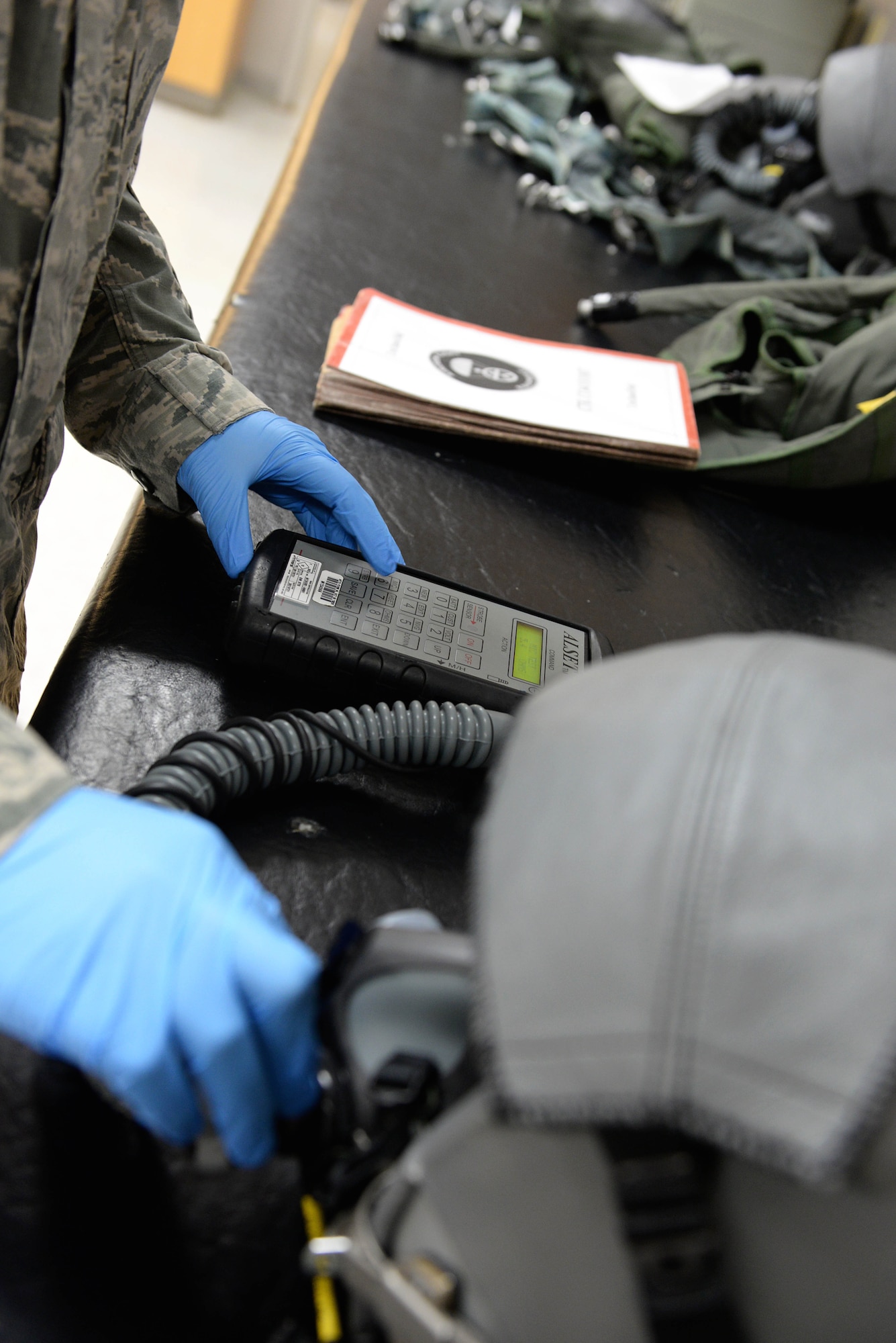 Staff Sgt. Marcus Tello, 41st and 37th Flying Training Squadron Aircrew Flight Equipment technician, checks the airflow of a helmet’s tube Dec. 5, 2017, on Columbus Air Force Base, Mississippi. If any equipment needs repaired, the AFE unit will test, evaluate and replace or fix the issue so pilots are ready to encounter any situation during their flights. (U.S. Air Force photo by Airman 1st Class Keith Holcomb)