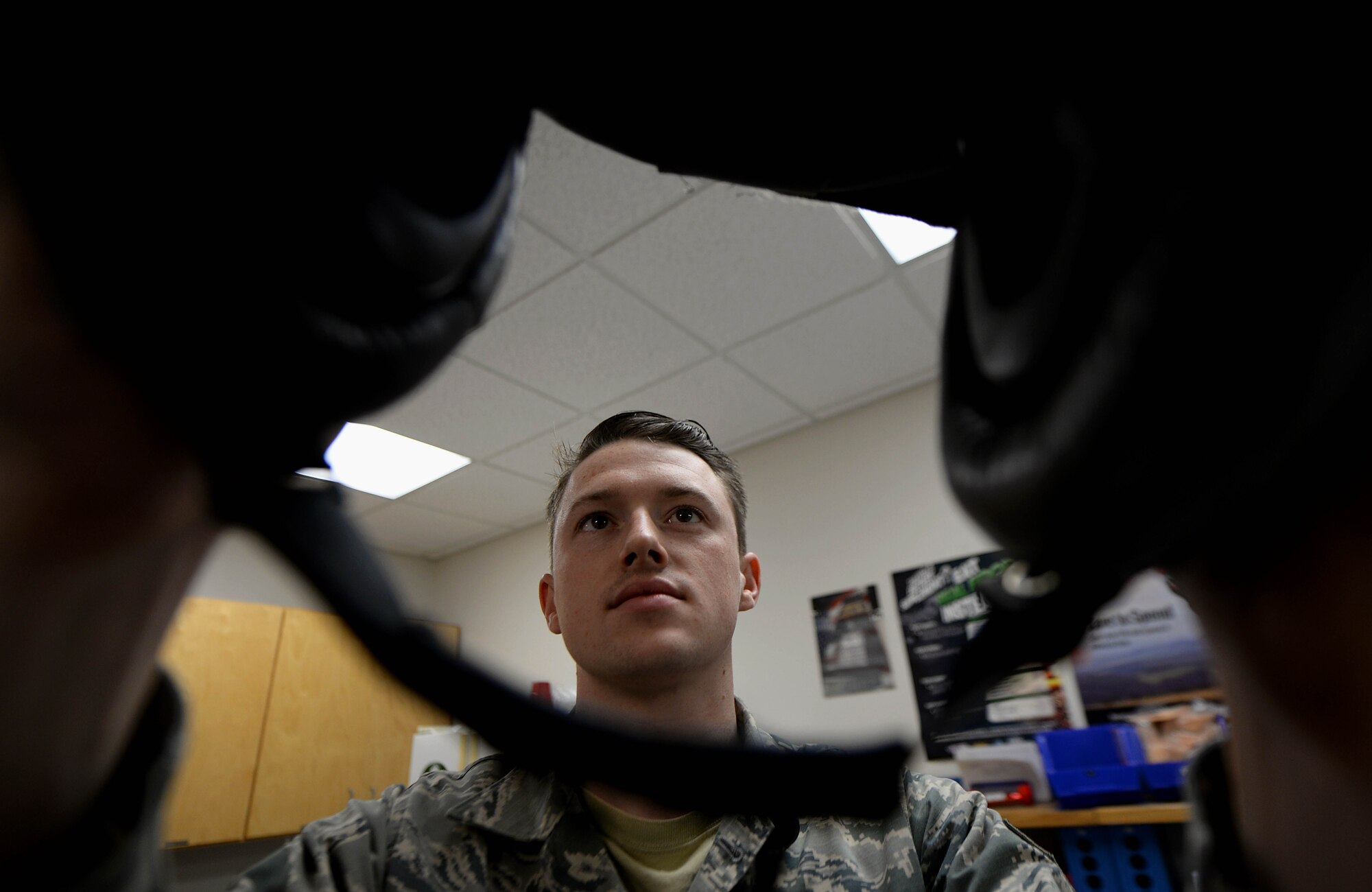 Senior Airman Hayden Harrison, 48th Flying Training Wing Aircrew Flight Equipment technician, inspects a helmet’s visor Dec. 5, 2017, on Columbus Air Force Base, Mississippi. At Columbus AFB, AFE Airmen do not have to learn how to sew together parachutes or pilots’ G-suits, but do have to learn how to fix hundreds of helmets, harnesses and survival kits every year. (U.S. Air Force photo by Airman 1st Class Keith Holcomb)