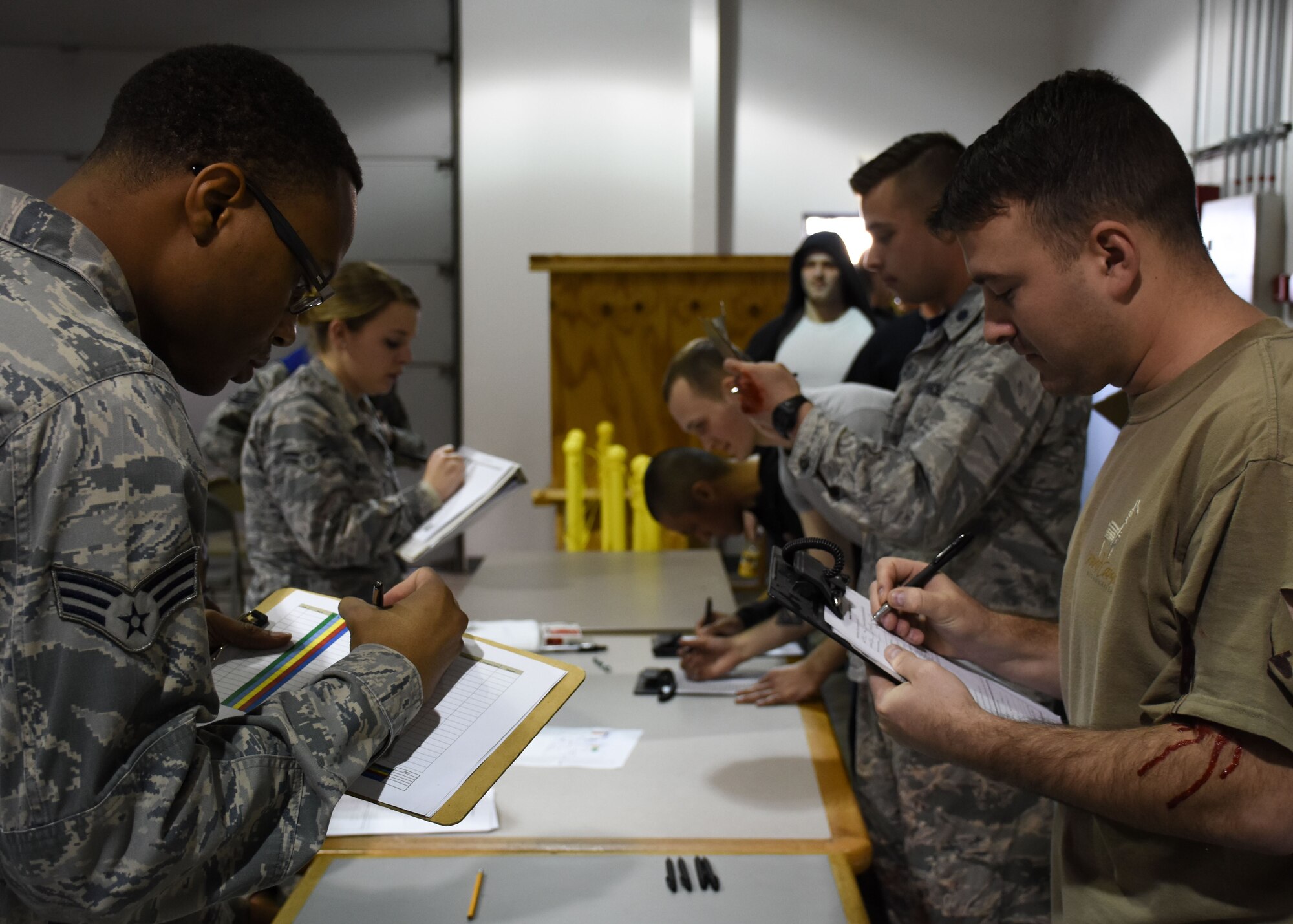 Members of the patient administration team and volunteers simulating flu symptoms complete screening forms during a total force point of distribution (POD) exercise at Whiteman Air Force Base, Mo., Dec. 2, 2017.