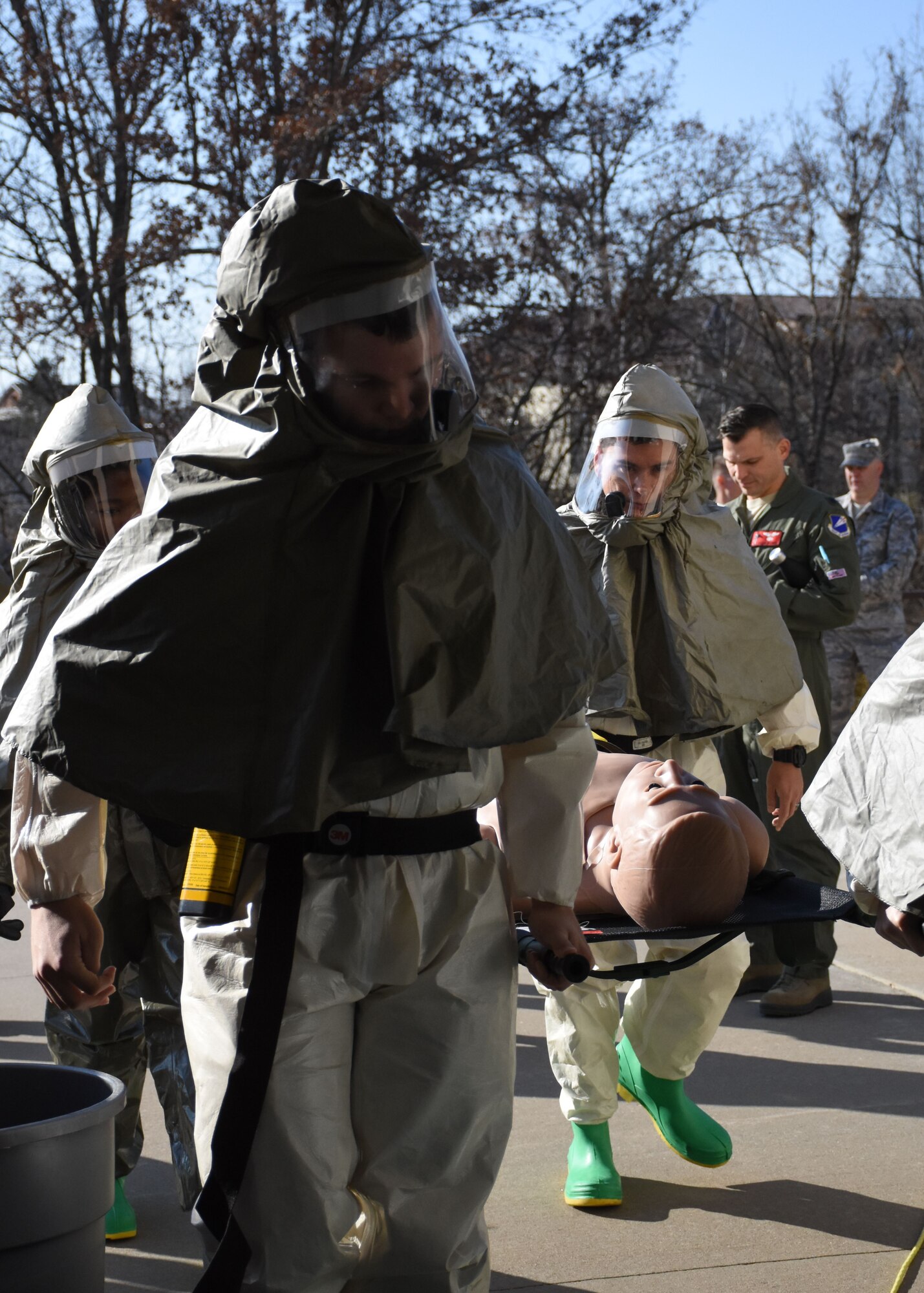 U.S. Air Force medical personnel from Team Whiteman carry a dummy through an in-place patient decontamination line during a total force mass casualty and point of distribution exercise at Whiteman Air Force Base, Mo., Dec. 2, 2017.