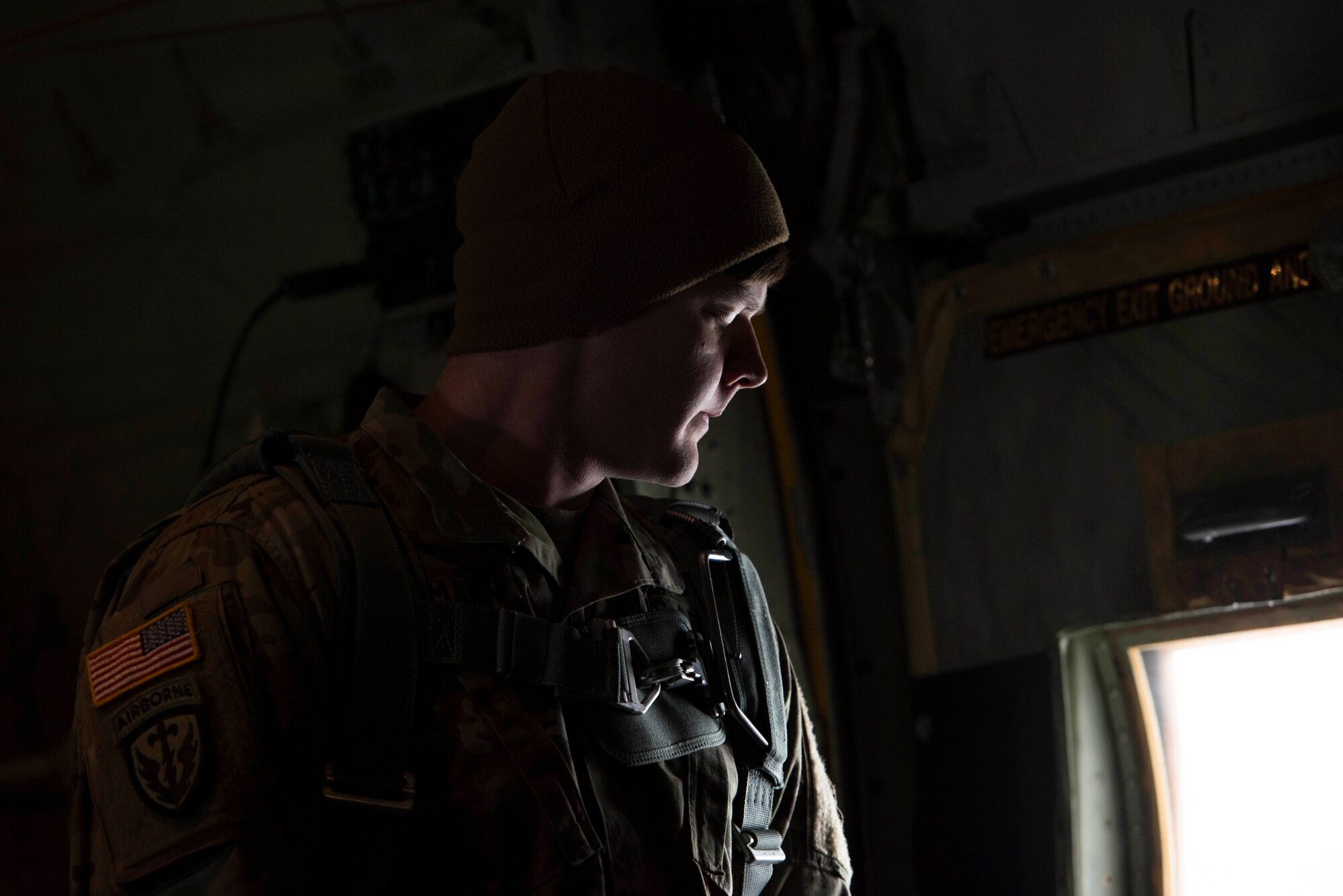 A U.S. Army jumpmaster looks out the window of a U.S. Air Force C-130J Super Hercules during a flight over Alzey Drop Zone, Germany, Dec. 6. 2017. The paratroopers participated in Operation Toy Drop 2017 to maintain their military free fall and jumpmaster proficiencies. (U.S. Air Force photo by Senior Airman Devin M. Rumbaugh)