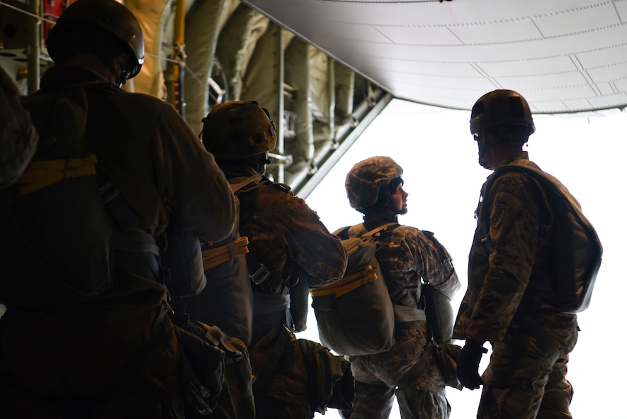 A U.S. Army paratrooper speaks to the U.S. Army jumpmaster prior to jumping out of the U.S. Air Force C-130J Super Hercules over Alzey Drop Zone, Germany, Dec. 6, 2017. The paratroopers performed static-line jumps out of the aircraft as a part of Operation Toy Drop 2017. (U.S. Air Force photo by Senior Airman Devin M. Rumbaugh)