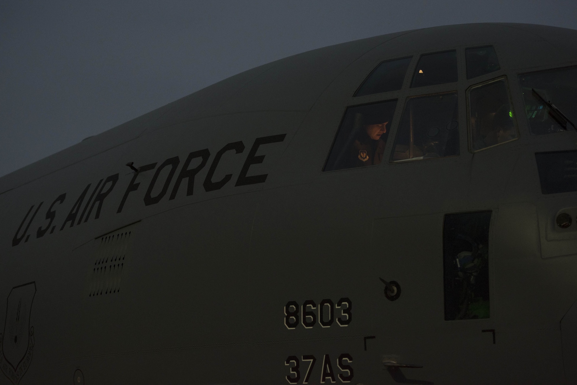 U.S. Air Force Maj. Aaron Sanchez, 86th Operations Support Squadron wing current operations chief, reviews flight plans for exercise Toy Drop 2017 in a U.S. Air Force C-130J Super Hercules on Ramstein Air Base, Germany, Dec. 6, 2017. Paratroopers with the U.S. Air Force, U.S. Army, German, Italian, Dutch, British, and Estonian militaries boarded two C-130J’s and performed static-line jumps over southern Germany. (U.S. Air Force photo by Senior Airman Devin M. Rumbaugh)