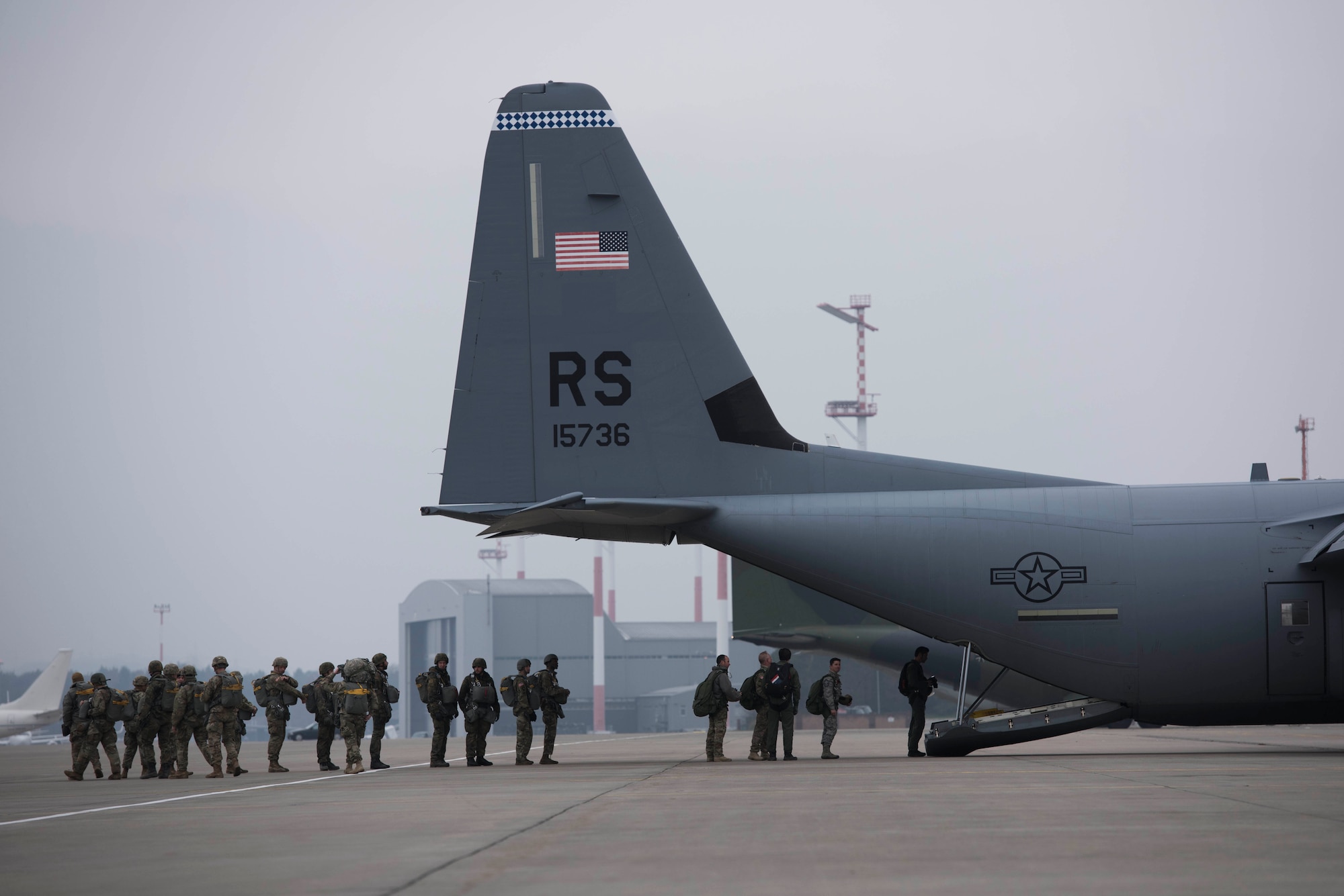 Paratroopers with the U.S. Air Force, U.S. Army, and German Air Force, prepare to board a U.S. Air Force C-130J Super Hercules on Ramstein Air Base, Germany, Dec. 6, 2017. The paratroopers participated in Operation Toy Drop 2017 to maintain their military free fall and jump master proficiencies. (U.S. Air Force photo by Senior Airman Devin M. Rumbaugh)