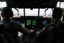 U.S. Air Force Capt. Jared Johnson (left) and U.S. Air Force 1st Lt. Kyle Holzem, both C-130J Super Hercules pilots assigned to the 37th Airlift Squadron, take off for Operation Toy Drop 2017, in a U.S. Air Force C-130J on Ramstein Air Base, Germany, Dec. 6, 2017. The aircraft flew over Alzey Drop Zone, Germany, where paratroopers from the U.S. Army, U.S. Air Force, German, Italian, Dutch, British, and Estonian militaries performed static-line jumps out of the aircraft. (U.S. Air Force photo by Senior Airman Devin M. Rumbaugh)