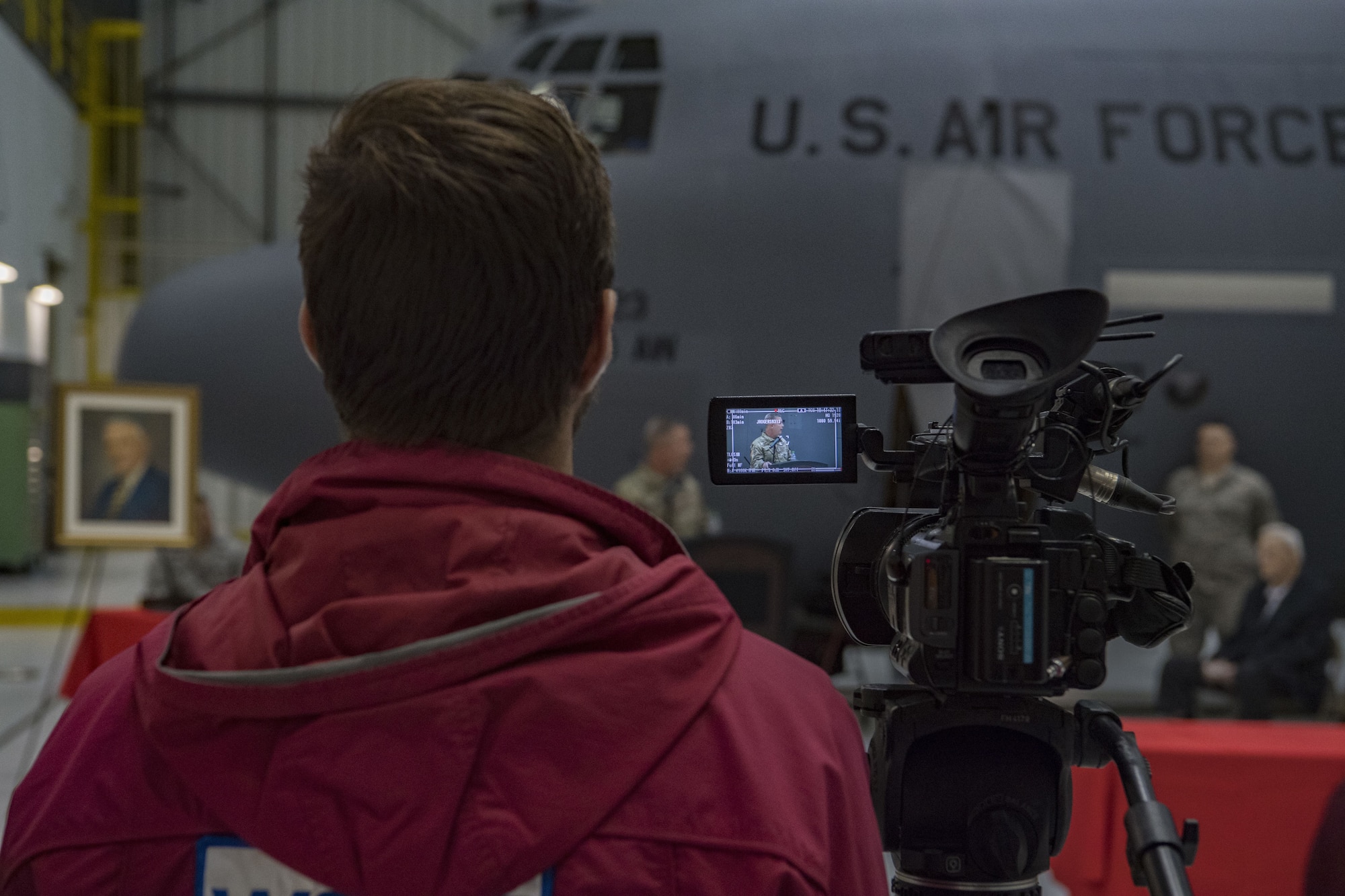 A local news reporter records a speech given by U.S. Army Maj. Gen. James Hoyer, the Adjutant General of the West Virginia National Guard, at a C-130H plane naming ceremony Dec. 7, 2017 at McLaughlin Air National Guard Base, Charleston, W.Va. The aircraft was given the name “The General Mac” to honor Brig. Gen. (ret) James K. McLaughlin, who founded the West Virginia Air National Guard and was a pilot in World War II with the famous Eight Air Force. (U.S. Air National Guard photo by Airman Caleb Vance)