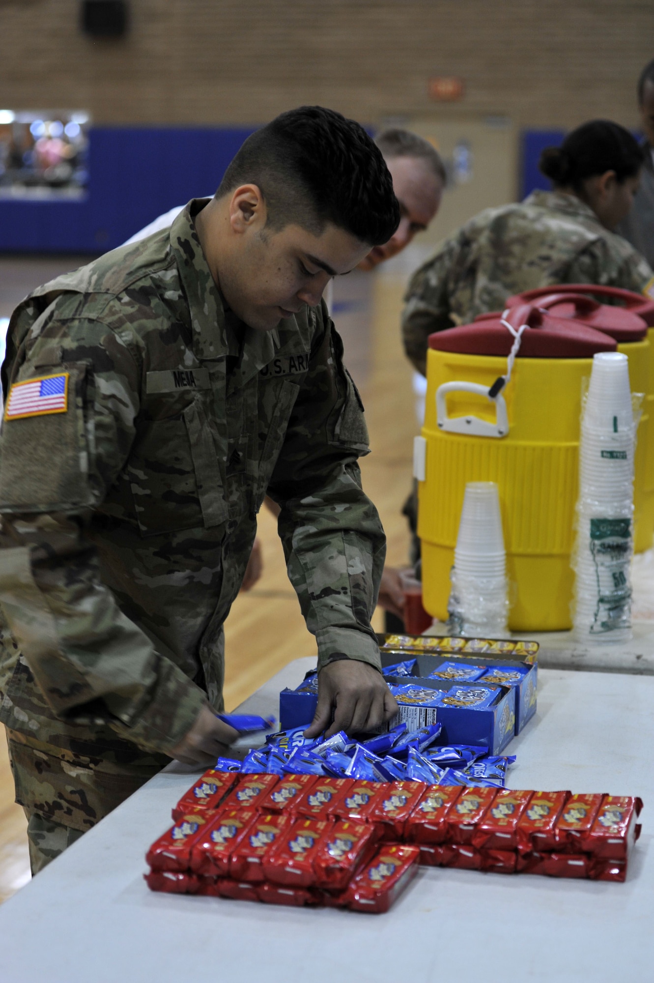 U.S. Army Sgt. Michael Mejia, William Bowman Hospital Army Medical Center lab technician, assists with the Armed Services Blood Program event at Luke Air Force Base, Ariz., Dec. 07, 2017. After the participants finished donating blood, cookies and juice were given to donors to prevent shock and rehydrate blood sugar levels.   (U.S. Air Force photo/Senior Airman Pedro Mota)