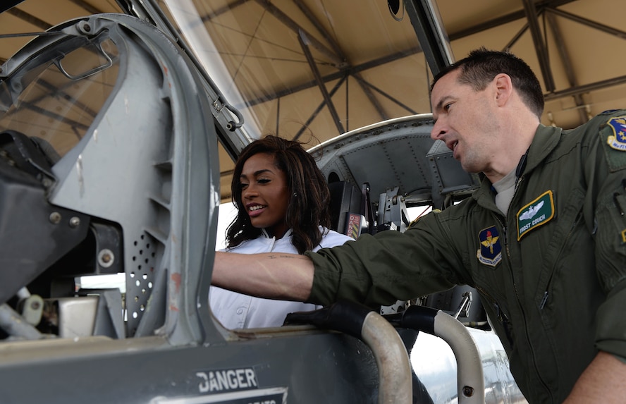 Khalyn, Dallas Cowboys Cheerleader, sits inside a T-38C Talon as Capt. James Couch, 49th Fighter Training Squadron Assistant Upgrading Instructor Pilot Flight Commander, talks about some of the key features during a tour of the flight line on Columbus Air Force Base Mississippi, Dec. 4, 2017. Numerous members of the cheerleading squad visited the base where they were shown the 14th Flying Training Wing mission and conducted a Cheer to Fitness Clinic for children at the Youth Center. (U.S. Air Force photo by Airman 1st Class Keith Holcomb)