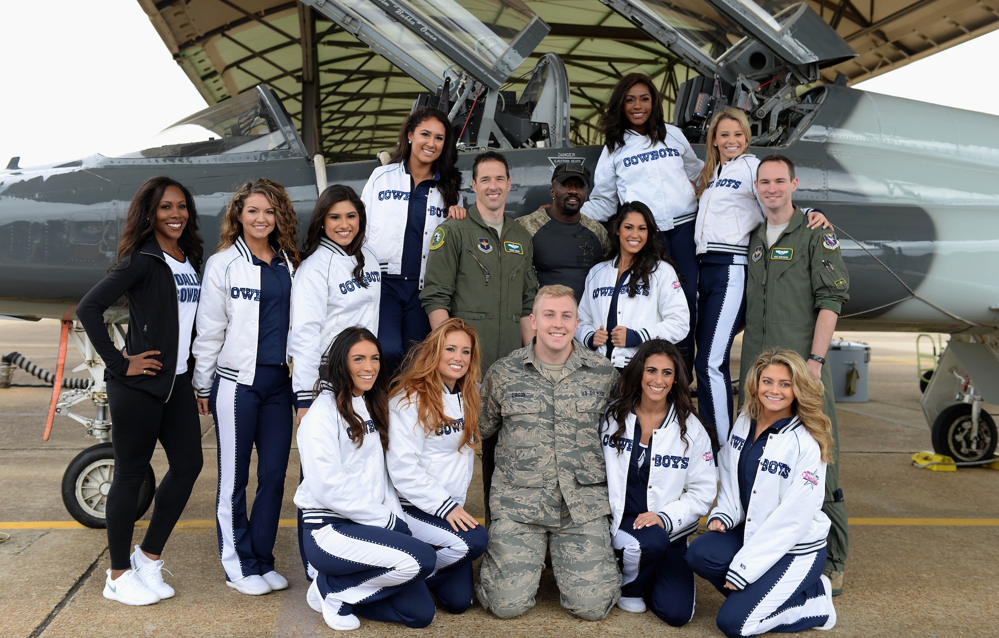 The Dallas Cowboys Cheerleaders stand with pilots next to a T-38C Talon Dec. 4, 2017, on the flight line at Columbus Air Force Base, Mississippi. The cheerleaders were able to sit inside the aircraft and ask questions to learn about the airframe and how it flies. (U.S. Air Force photo by Airman 1st Class Keith Holcomb)