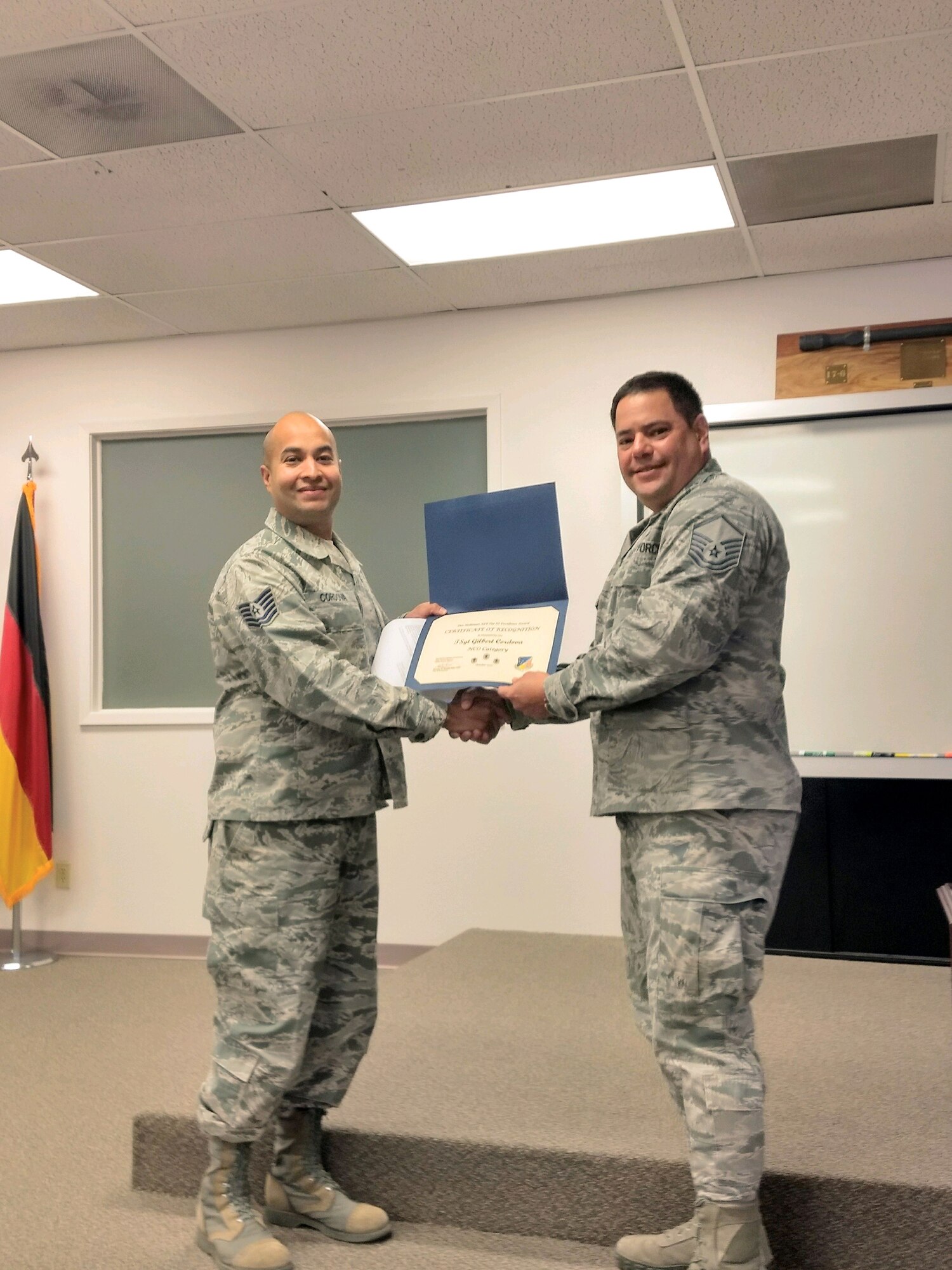Tech. Sgt. Gilbert Cordova, 49th Force Support Squadron Airman Leadership School instructor, receives the October Top III Noncommissioned Officer Award from Master Sgt. Moises Guzman-Roman, 49th Operation Support Squadron airfield flight superintendent and Top III treasurer, Nov. 28, 2017, at Holloman Air Force Base, N.M. During the month of October, Cordova partnered with the Alamo City Hall, police department, recreation center, municipal court, public library and the clerks office. This coordination set up and judged 15 categories for 10 city of Alamogordo Halloween festivities, which was attended by 400 people. He also completed six defense acquisition university courses while instructing an ALS class and mentored 32 students from 12 different Air Force specialty codes.