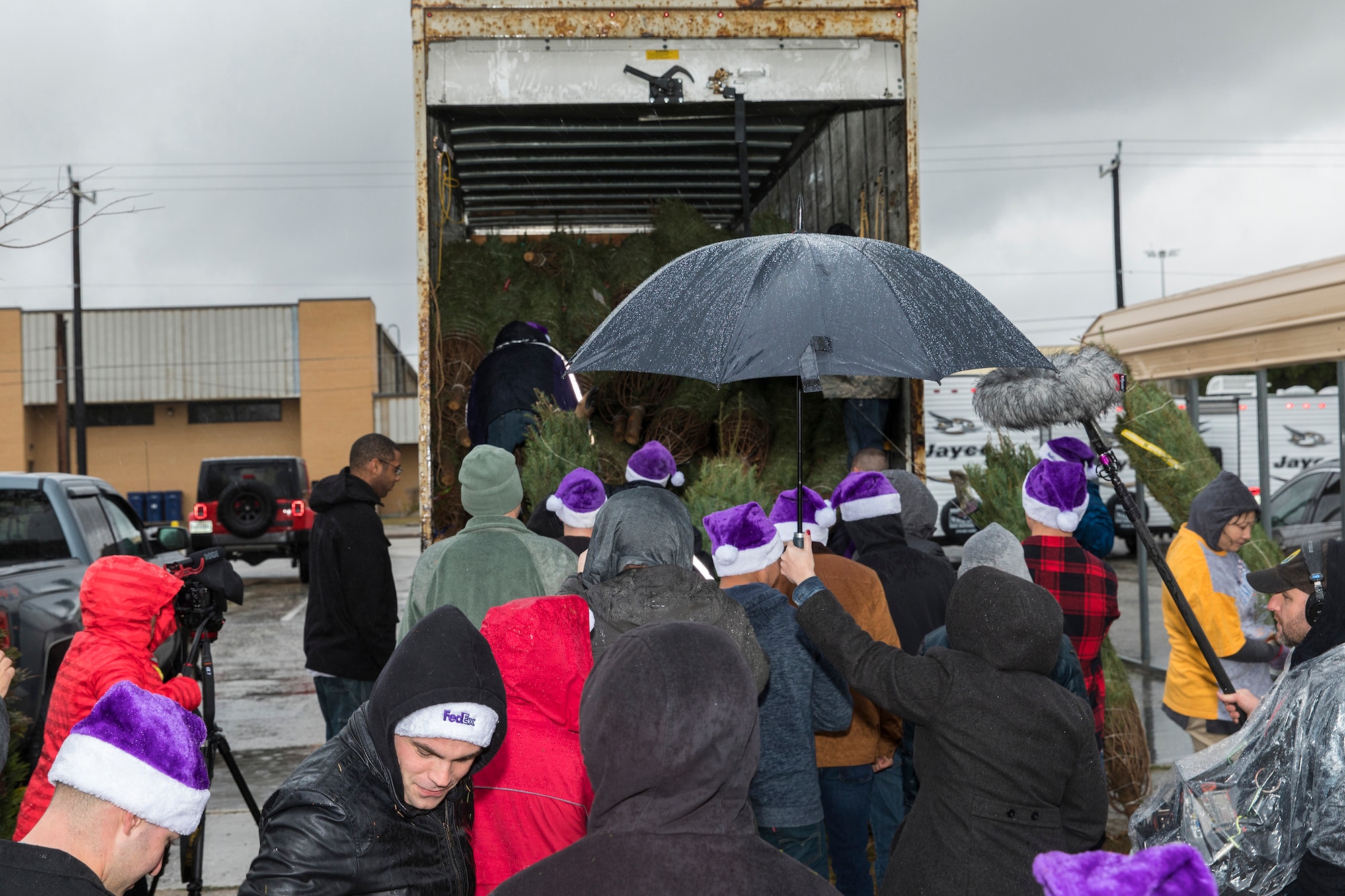 Volunteers unload Christmas trees at Joint Base San Antonio-Lackland donated by the Christmas SPIRIT Foundation, FedEx and 18 tree farmers as part of the Trees for Troops program Dec. 7, 2017.