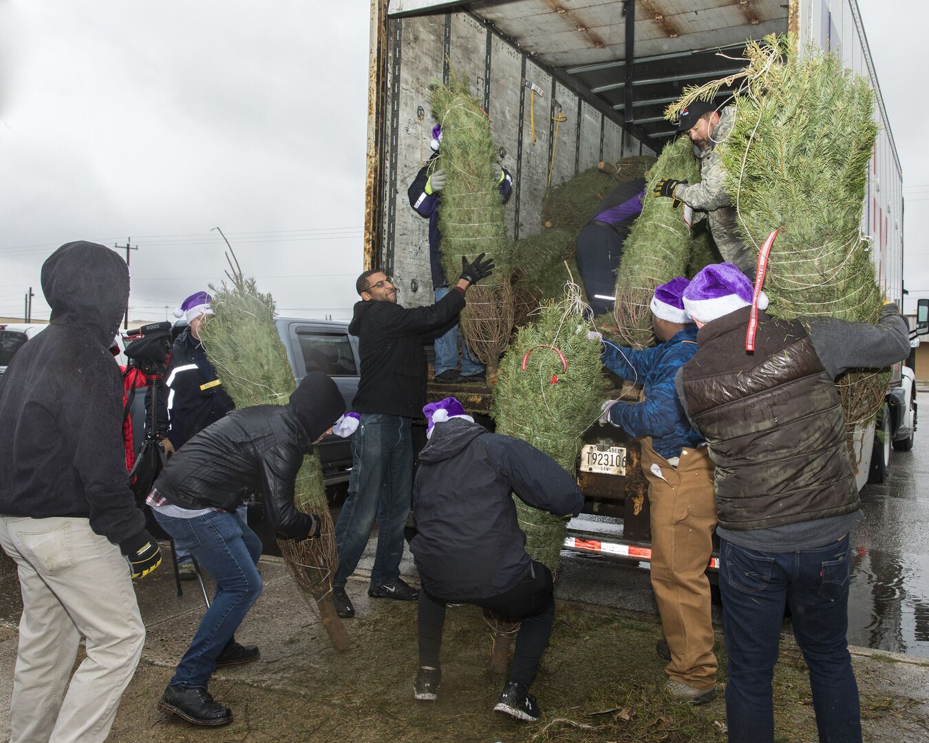 Volunteers unload Christmas trees at Joint Base San Antonio-Lackland donated by the Christmas SPIRIT Foundation, FedEx and 18 tree farmers as part of the Trees for Troops program Dec. 7, 2017.