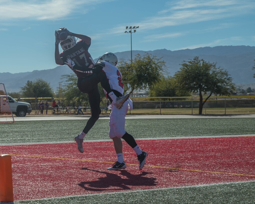 A player from the Headquarters and Service Battalion team scores a touchdown during the Best in the West Game at Felix Field aboard the Marine Corps Air Ground Combat Center, Twentynine Palms, Calif., Dec. 02, 2017. The Best in the West Game consisted of Camp Pendleton’s Headquarters and Service Battalion team and the Combat Center’s 1st Tank Battalion team. (U.S. Marine Corps photo by Lance Cpl. Preston L. Morris)