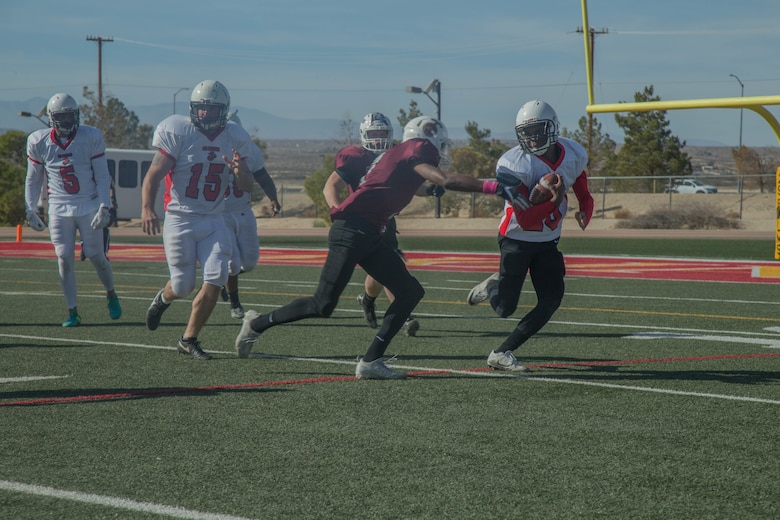 A player from the 1st Tank Battalion team runs the ball back following a kick return during the Best in the West Game at Felix Field aboard the Marine Corps Air Ground Combat Center, Twentynine Palms, Calif., Dec. 02, 2017. The Best in the West Game consisted of Camp Pendleton’s Headquarters and Service Battalion team and the Combat Center’s 1st Tank Battalion team. (U.S. Marine Corps photo by Lance Cpl. Preston L. Morris)