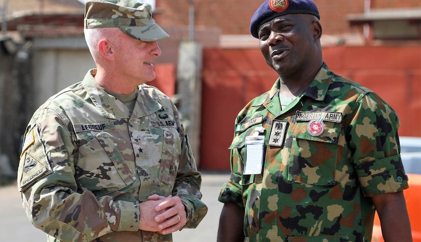 Army Brig. Gen. Eugene J. LeBoeuf, the U.S. Army Africa acting commanding general, meets with Col. R.L. Pam during an equipment handover between the U.S. Embassy to Nigeria and Nigeria army's 20th Infantry Battalion in Abuja, Nigeria.