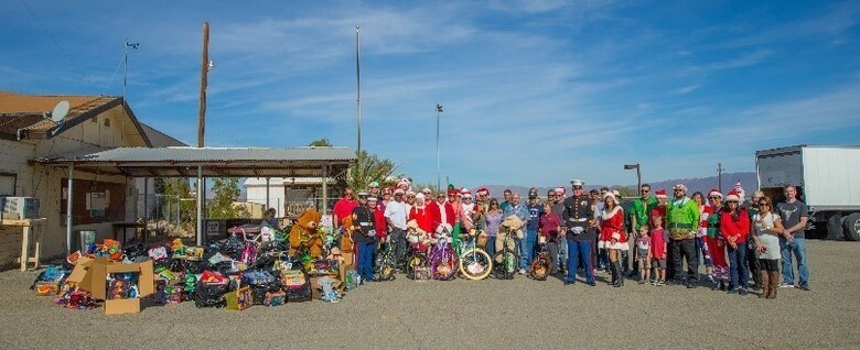 Theodore Gablin, President of the Redlands Airport Association, poses with one of the bicycles donated to the Toys for Tots foundation at the Twentynine Palms airport Dec. 2, 2017. This event marked the third-annual Toys for Tots Fly-in. (U.S. Marine Corps photo by Lance Cpl. Ashlee Conover)