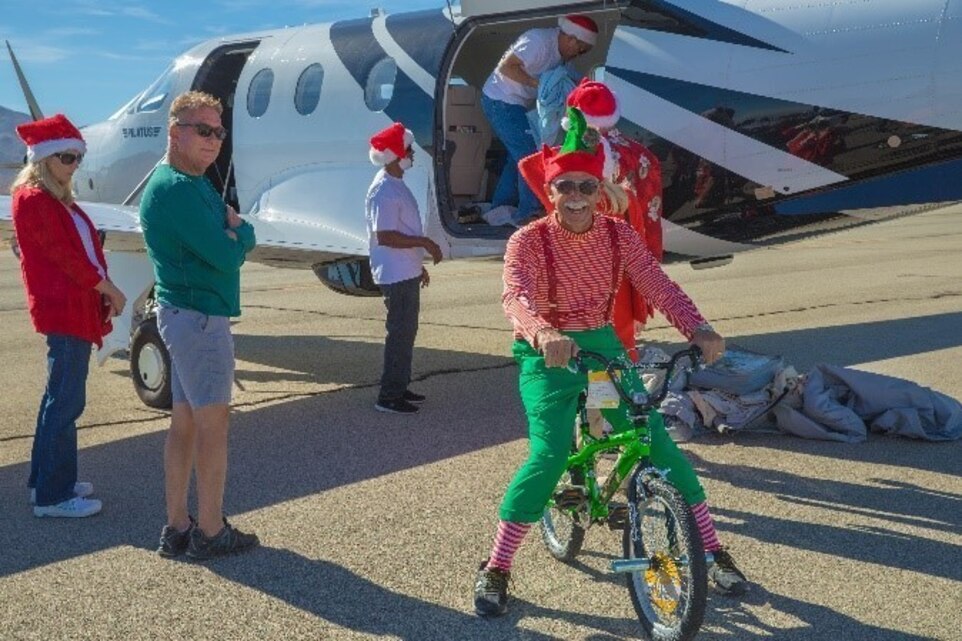 Theodore Gablin, President of the Redlands Airport Association, poses with one of the bicycles donated to the Toys for Tots foundation at the Twentynine Palms airport Dec. 2, 2017. This event marked the third-annual Toys for Tots Fly-in. (U.S. Marine Corps photo by Lance Cpl. Ashlee Conover)