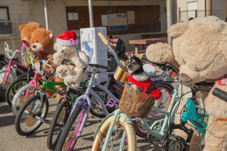 Theodore Gablin, President of the Redlands Airport Association, poses with one of the bicycles donated to the Toys for Tots foundation at the Twentynine Palms airport Dec. 2, 2017. This event marked the third-annual Toys for Tots Fly-in. (U.S. Marine Corps photo by Lance Cpl. Ashlee Conover)