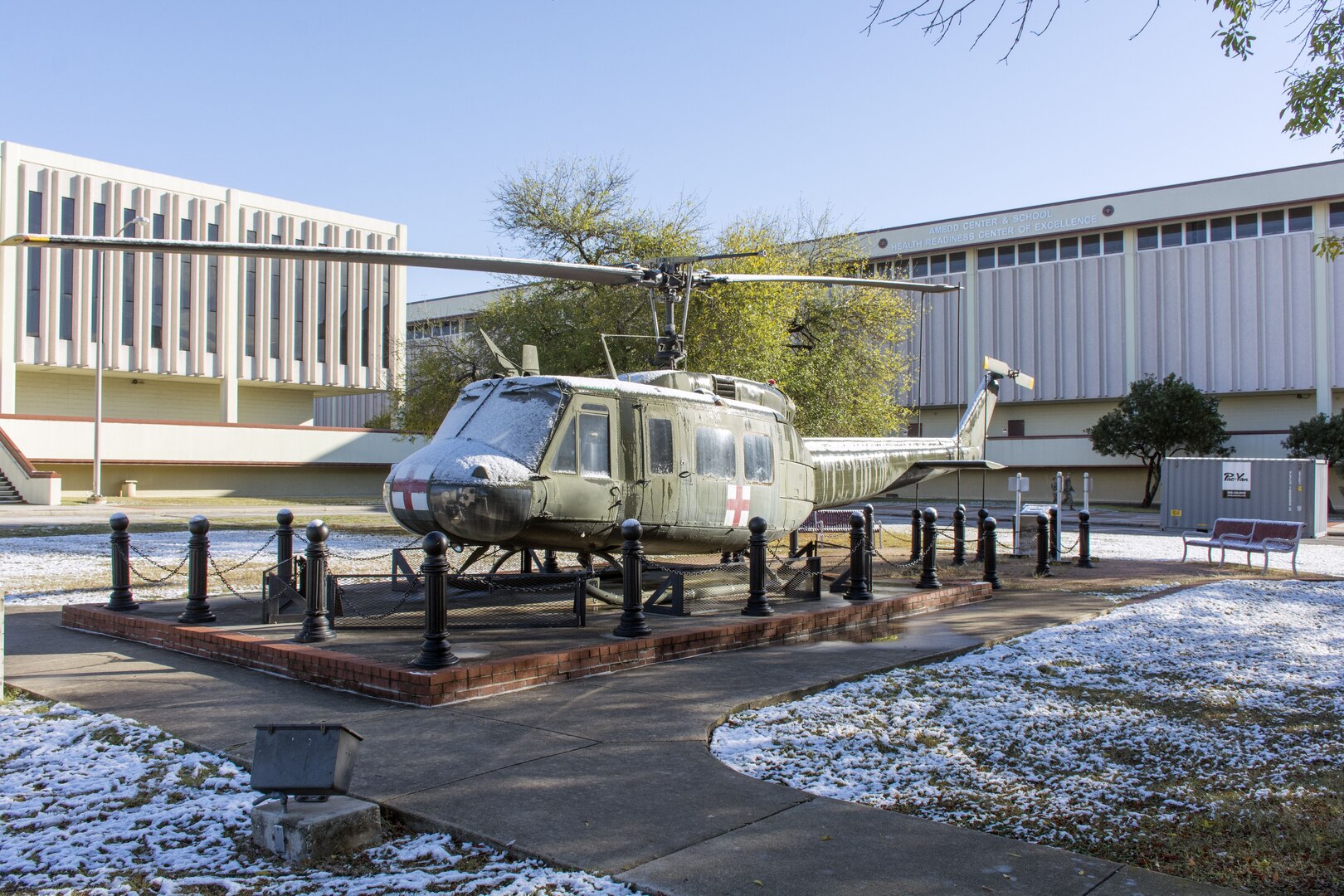 The UH-1 helicopter on display at the U.S. Army Medical Department Center and School partially covered in snow. Thursday's event was the earliest seasonal snowfall on record for San Antonio.