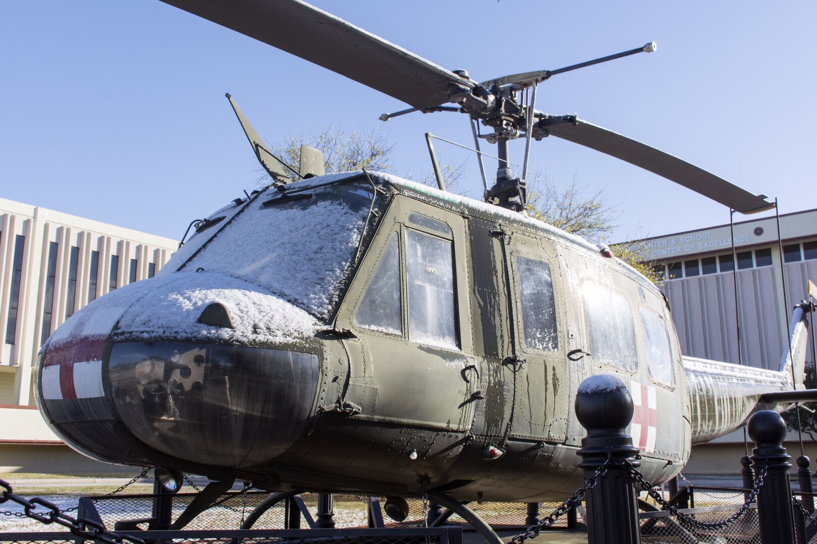 The UH-1 helicopter on display at the U.S. Army Medical Department Center and School partially covered in snow. Thursday's event was the earliest seasonal snowfall on record for San Antonio.