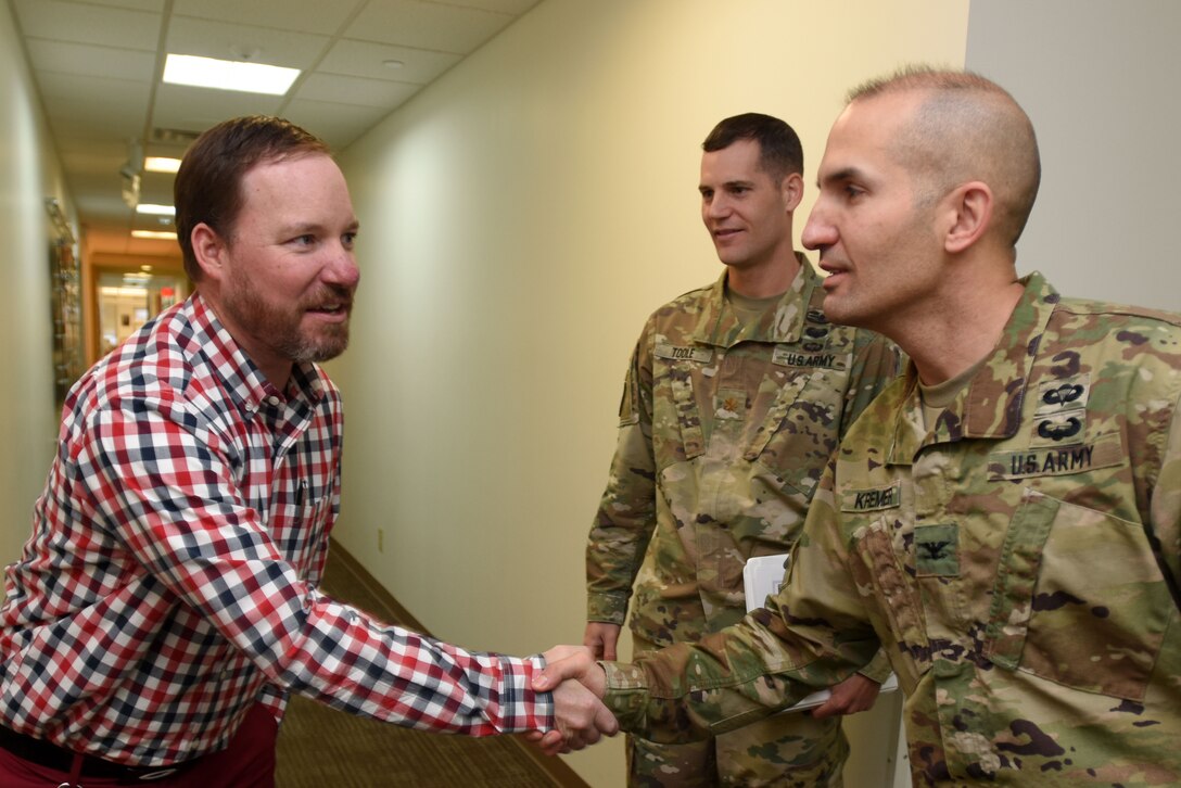 Col. Paul Kremer (Right), U.S. Army Corps of Engineers Great Lakes and Ohio River Division acting commander, meets Tavis Hanley, acting Operations Division deputy chief, during a tour of the Nashville District Headquarters in Nashville, Tenn., Dec. 6, 2017. Maj. Justin Toole (Background), Nashville District deputy commander, accompanied the colonel on the tour. (USACE photo by Lee Roberts)
