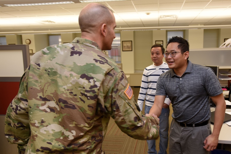 Col. Paul Kremer (Left), U.S. Army Corps of Engineers Great Lakes and Ohio River Division acting commander, meets Cuong Vo (shaking hands), mechanical engineer, and Son Pham, electrical engineer in the Navigation Section, during a tour of the Nashville District Headquarters in Nashville, Tenn., Dec. 6, 2017. (USACE photo by Lee Roberts)