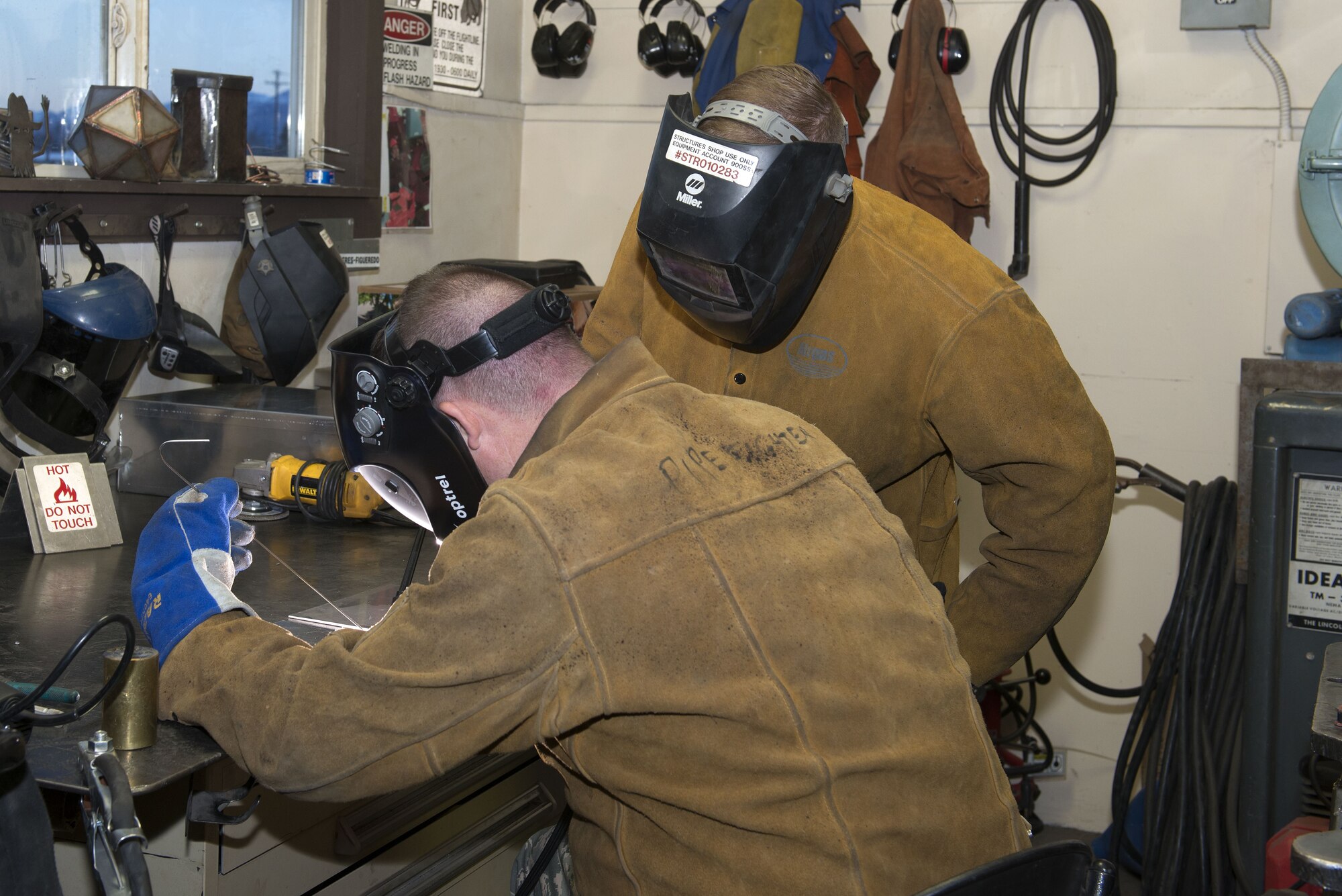 Air Force Staff Sgt. Levi Smelser and Airman 1st Class Taylor Zehr, both 773d Civil Engineer Squadron Airmen, practice welding on scrap metal at the construction shop on Joint Base Elmendorf-Richardson, Alaska. The construction shop repairs and performs maintenance on doors, windows, framing, airfield damage and much more.