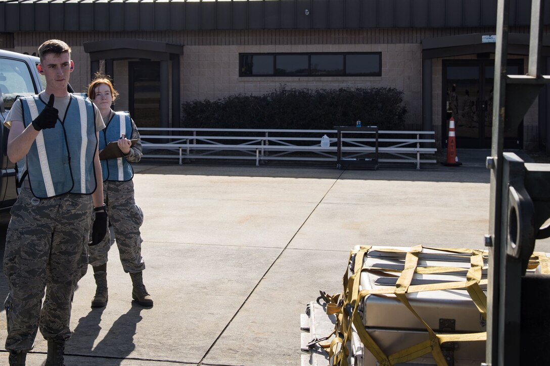 Airman 1st Class Steven Raulston, 23d Logistics Readiness Squadron fuels distribution operator, marshals a forklift, Dec. 4, 2017, at Moody Air Force Base, Ga. Moody’s Phase 1, Phase 2 exercise tested the 23d Wing’s operations, maintenance and logistics squadron’s readiness to rapidly deploy. Airmen from the 23d Logistics Readiness Squadron where evaluated on their ability to inspect 30 units of cargo estimated to weigh 70 tons efficiently when received in a rapid manner. (U.S. Air Force photo by Airman Eugene Oliver)