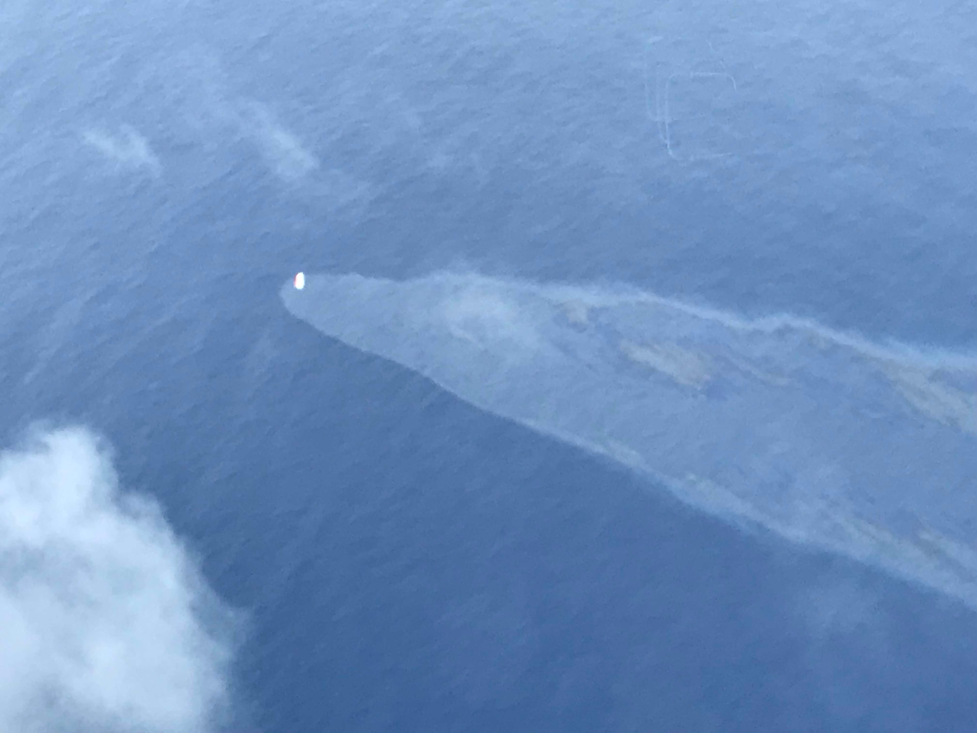 The Gyotokumaru No. 1, a civilian fishing vessel sinks 900 miles southwest of Guam as seen from a KC-135R aircraft during a search and rescue mission. The Aircraft was crewed by Pennsylvania Air National Guardsmen from the 171st Air Refueling Wing, who were deployed to Andersen AFB Nov. 21, 2017. (U.S. Air National Guard Photo)