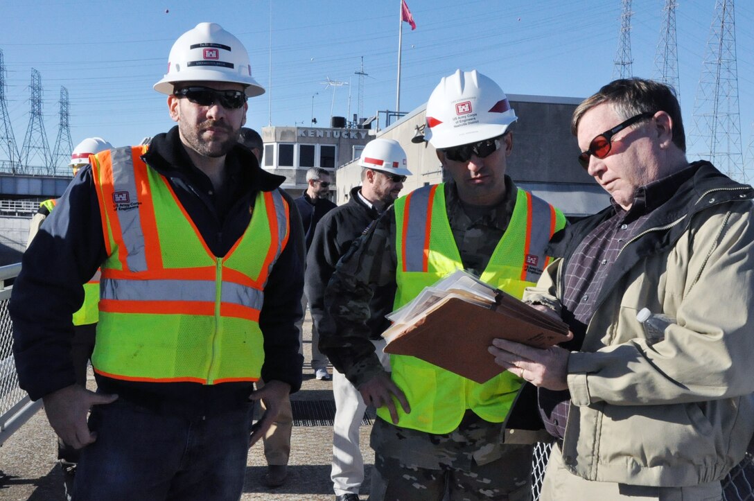 Don Getty (Right), project manager for the Kentucky Lock Addition Project, describes operations to Col. Paul Kremer (Center), U.S. Army Corps of Engineers Great Lakes and Ohio River Division acting commander, during a visit Dec. 6, 2017. Caleb Skinner, Kentucky Lock Master, at the Kentucky Lock also provided input during the tour. (USACE photo by Mark Rankin)