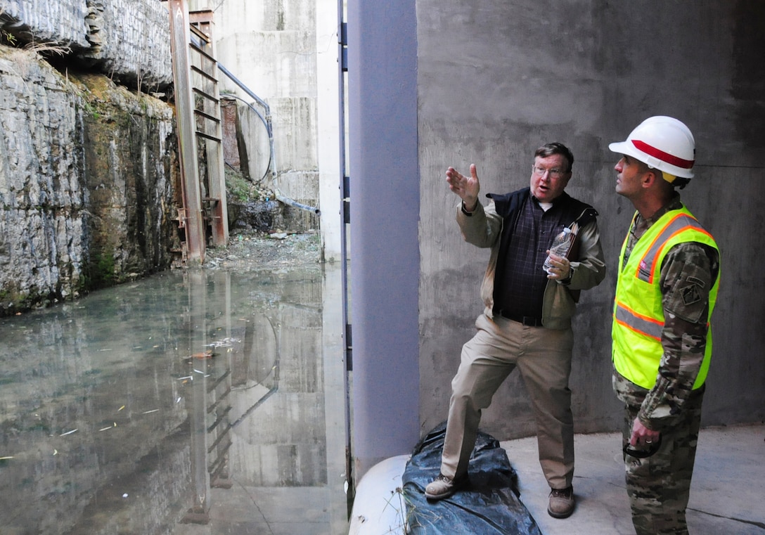 Don Getty, project manager for the Kentucky Lock Addition Project, describes lock wall and valve operations to Col. Paul Kremer, U.S. Army Corps of Engineers Great Lakes and Ohio River Division acting commander, during a visit inside the project Dec. 6, 2017 in Grand Rivers, Ky. (USACE photo by Mark Rankin)
