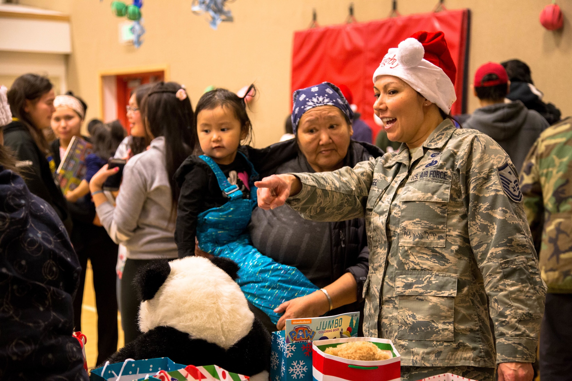 The children of St. Michael, Alaska, visit with volunteers and Alaska National Guard members during Operation Santa Claus Dec. 5, 2017. Operation Santa Claus is an Alaska National Guard annual community outreach program that provides Christmas gifts, books, back packs filled with school supplies, fresh fruit and sundaes to youngsters in rural communities.