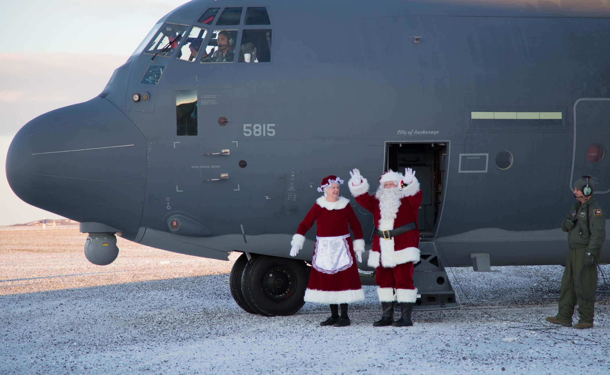 Mr. and Mrs. Santa Claus, travelling with Operation Santa Claus, de-board an HC-130J Combat King II aircraft from the 211th Rescue Squadron, Alaska Air National Guard, after landing in St. Michael, Alaska, Dec. 5, 2017. Operation Santa Claus is an Alaska National Guard annual community outreach program that provides Christmas gifts, books, backpacks filled with school supplies, fresh fruit and sundaes to youngsters in rural communities. (U.S. Army National Guard photo by 2nd Lt. Marisa Lindsay)
