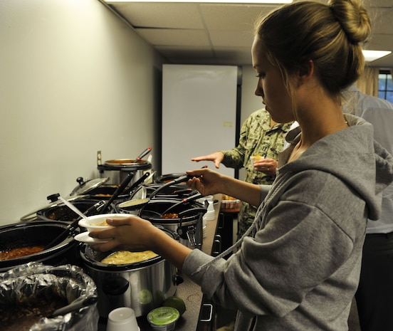 Airman 1st Class Gloria Voitushenko, 437th Aerial Port Squadron air transportation Airman, serves herself chili during a dormitory dinner hosted by dormitory management Dec. 6, 2017, at Joint Base Charleston, S.C.