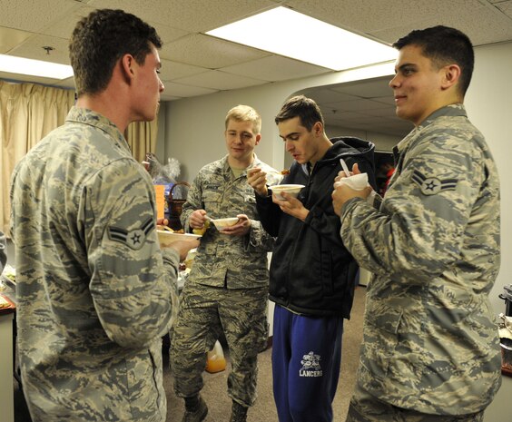 Joint Base Charleston dormitory residents converse while sampling homemade chili during a dormitory dinner Dec. 6, 2017, at Joint Base Charleston, S.C.