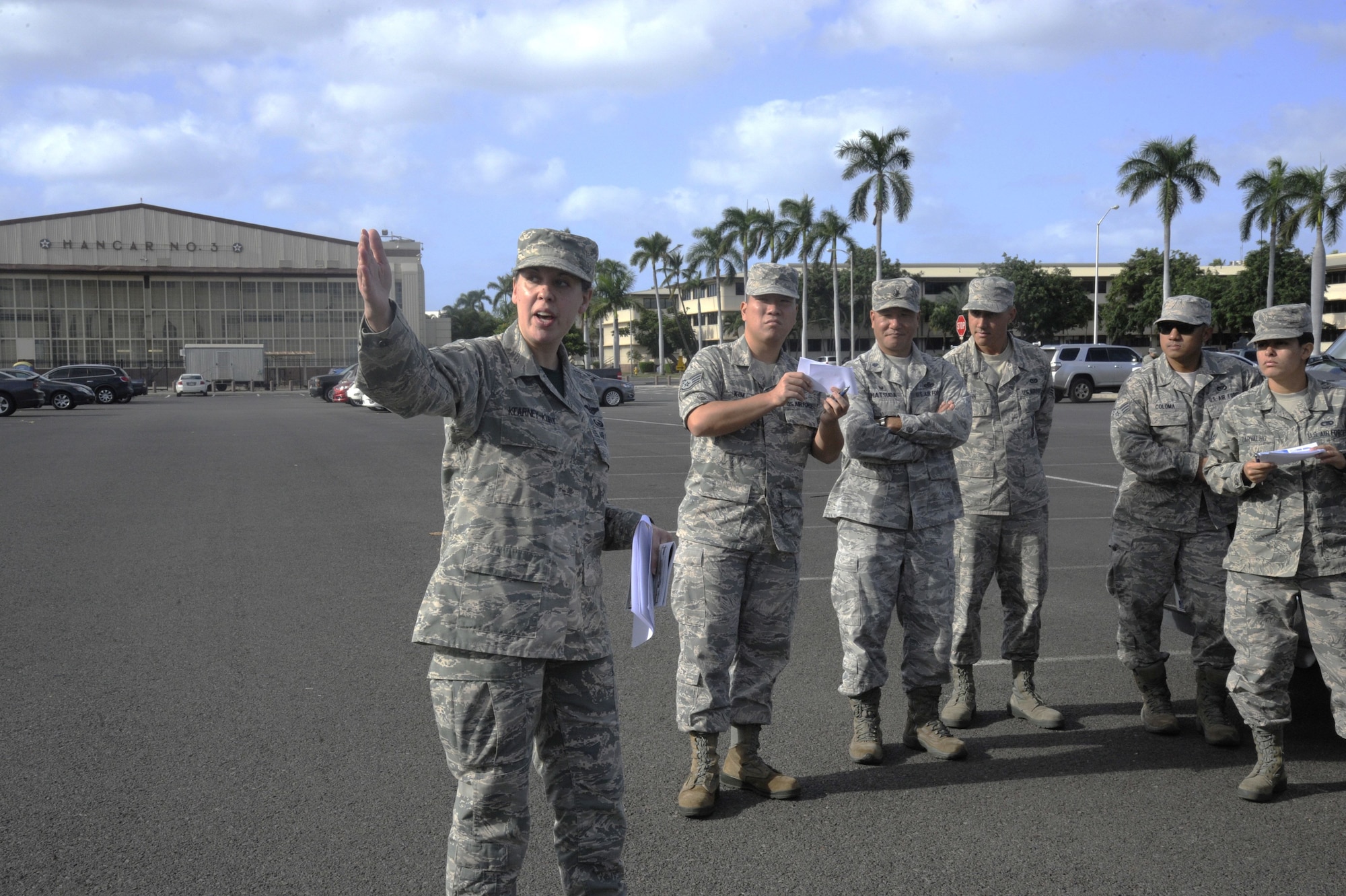 Reserve Citizen Airman Tech. Sgt. Christine Kearney-Kurt, a historian for the 624th Regional Support Group, explains the historic significance of the Base Operations building during a battlefield staff ride at Joint Base Pearl Harbor-Hickam, Hawaii, Dec. 3, 2017. The tour focused on the remnants of war from 76 years ago during the Dec. 7, 1941, attack at Hickam Field when America was launched into World War II. (U.S. Air Force photo by Master Sgt. Theanne Herrmann)