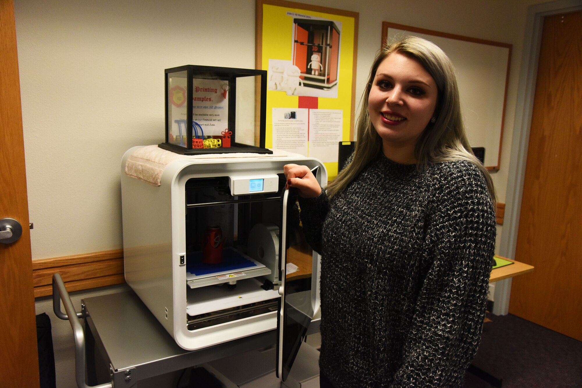 Teia Storm, 341st Force Support Squadron library aide, poses for a photo in front of a 3-D printer Dec. 6, 2017, at Arden G. Hill Memorial Library, Malmstrom Air Force Base, Mont.