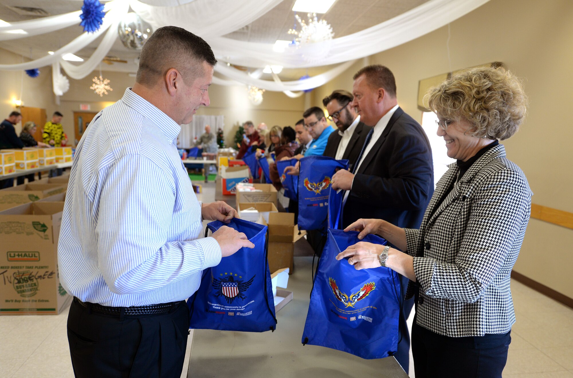 Volunteers with “Operation Holiday Cheer” help assemble bags filled with food, treats, and thank you’s at the Bellevue Volunteer Fire Department hall in Bellevue, Neb. Dec. 5, 2017 as part of “Operation Holiday Cheer."