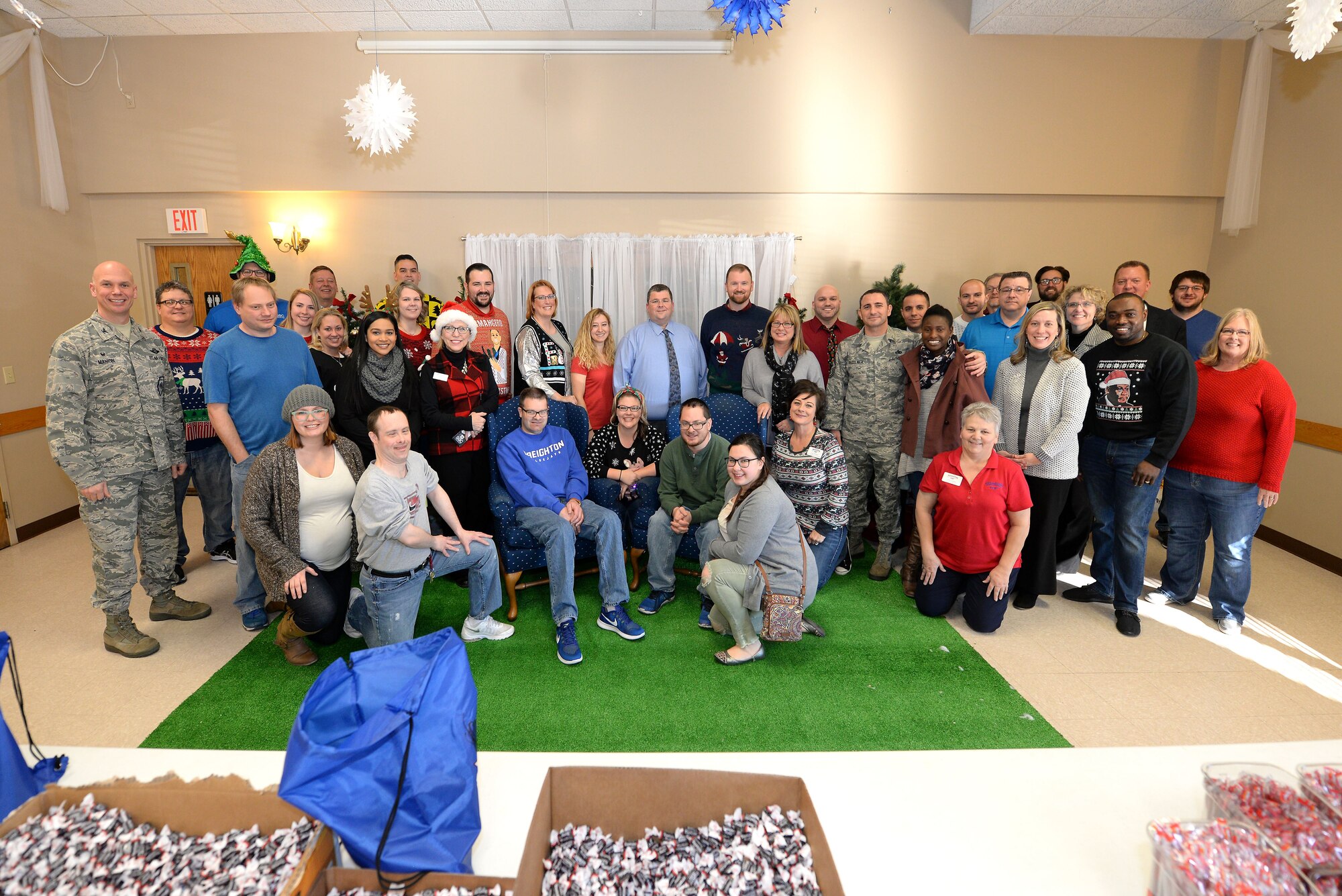 Volunteers with “Operation Holiday Cheer” pose for a photo at the Bellevue Volunteer Fire Department hall in Bellevue, Neb. Dec. 5, 2017.