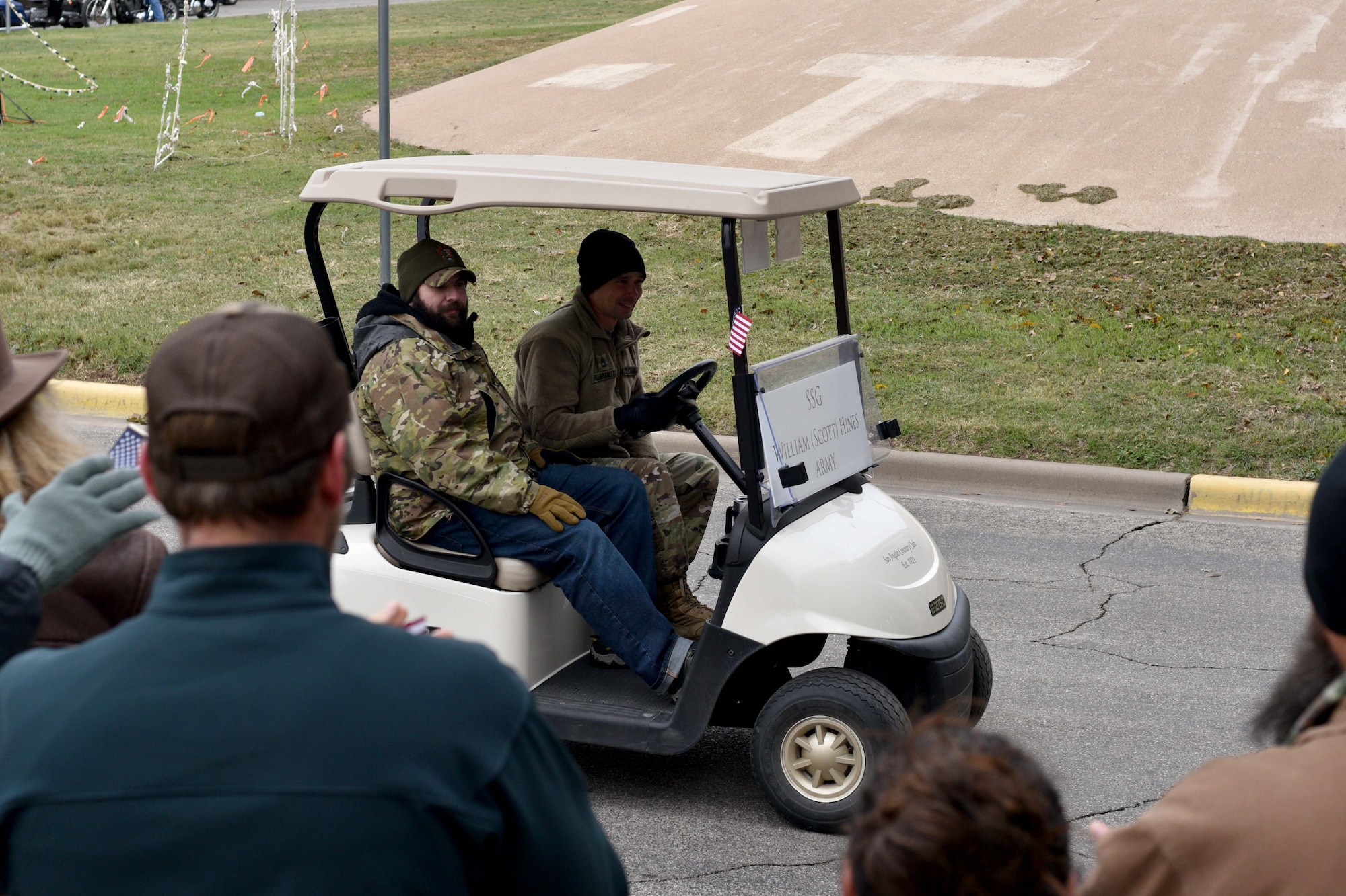 Bystanders applaud U.S. Army Staff Sgt. William Hines, wounded veteran, and Sgt. 1st Class David Fillbrandt, 344th Military Intelligence Battalion instructor, during the Heroes Hunt parade in San Angelo, Texas, Dec. 7, 2017.  The event included a breakfast potluck, music from the Central High School Band and a parade.