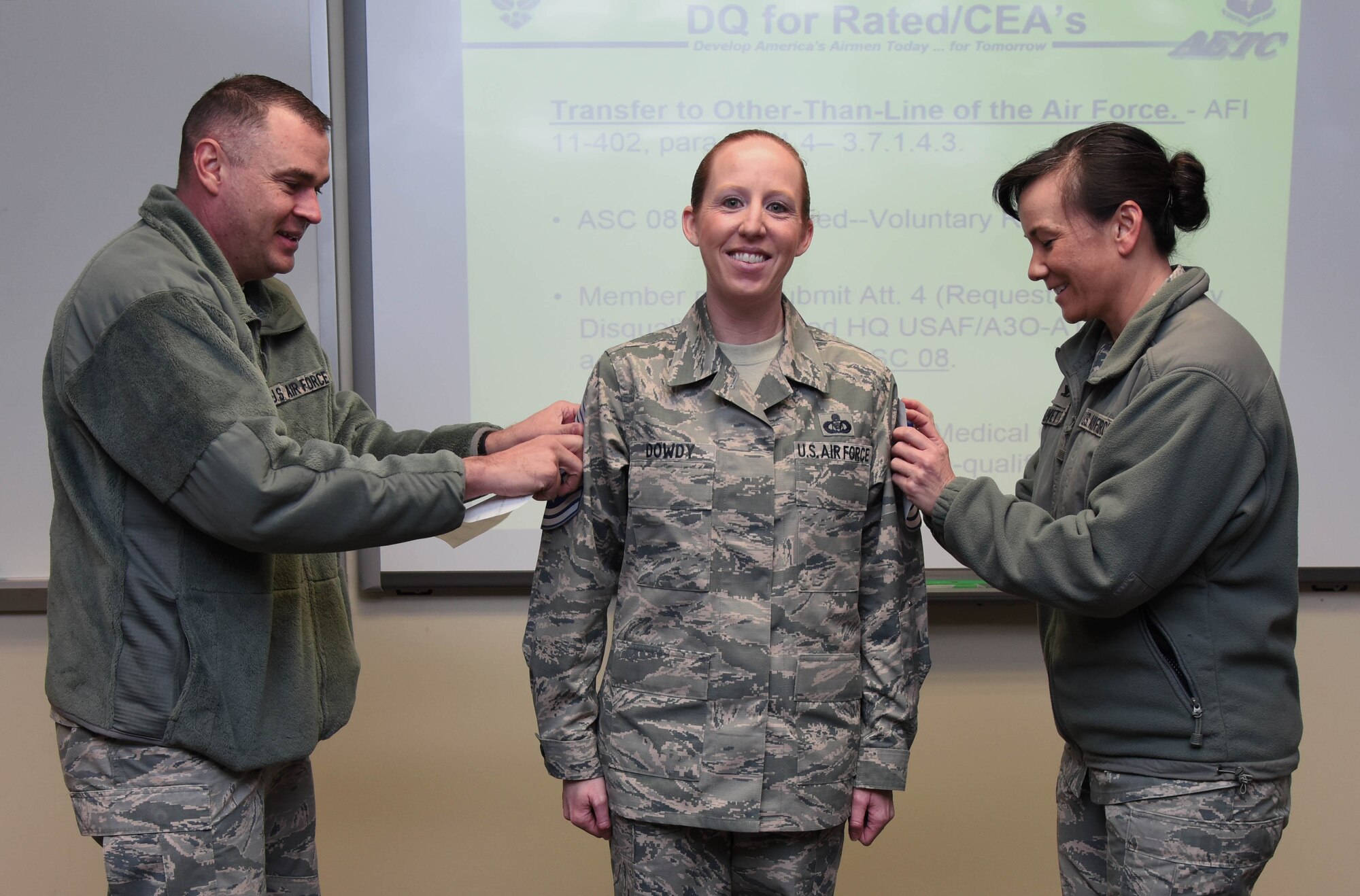 Chief Master Sgt. Leonard Trombley, 81st Training Support Squadron superintendent, and Col. Debra Lovette, 81st Training Wing commander, present Senior Master Sgt. Jessika Dowdy, 334th Training Squadron command and control training flight superintendent, with chief master sergeant stripes at Cody Hall Dec. 7, 2017, on Keesler Air Force Base, Mississippi. Keesler senior NCOs were recognized for their selection to join the top one percent of the Air Force’s enlisted force. (U.S. Air Force photo by Kemberly Groue)